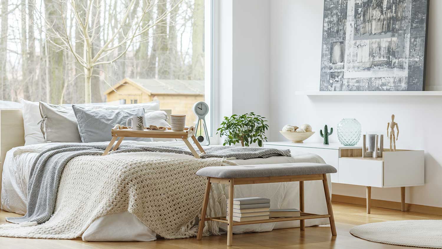 Bright stylish bedroom with big window