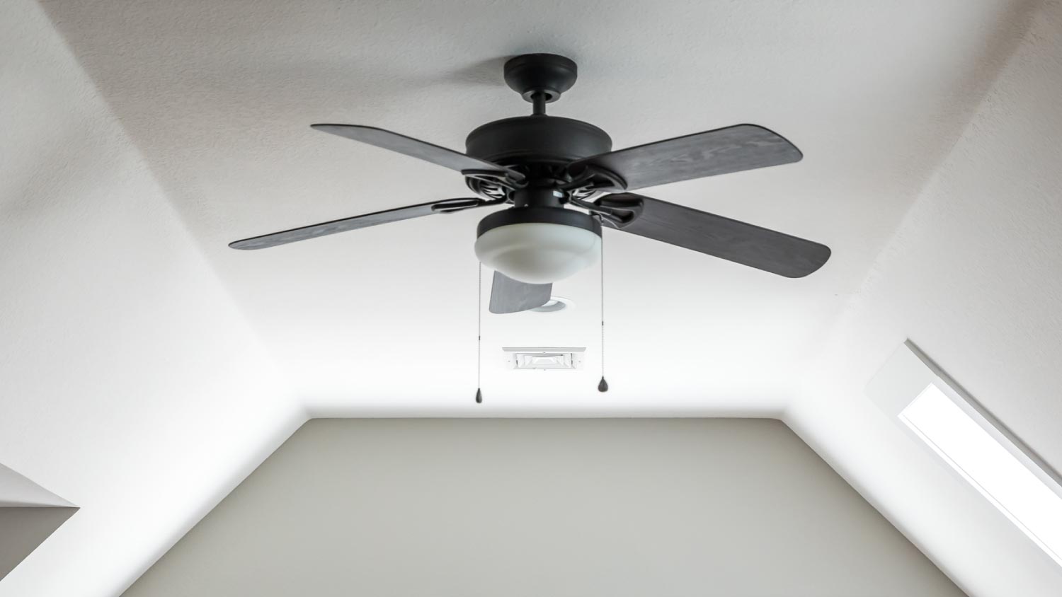A dark wood ceiling fan