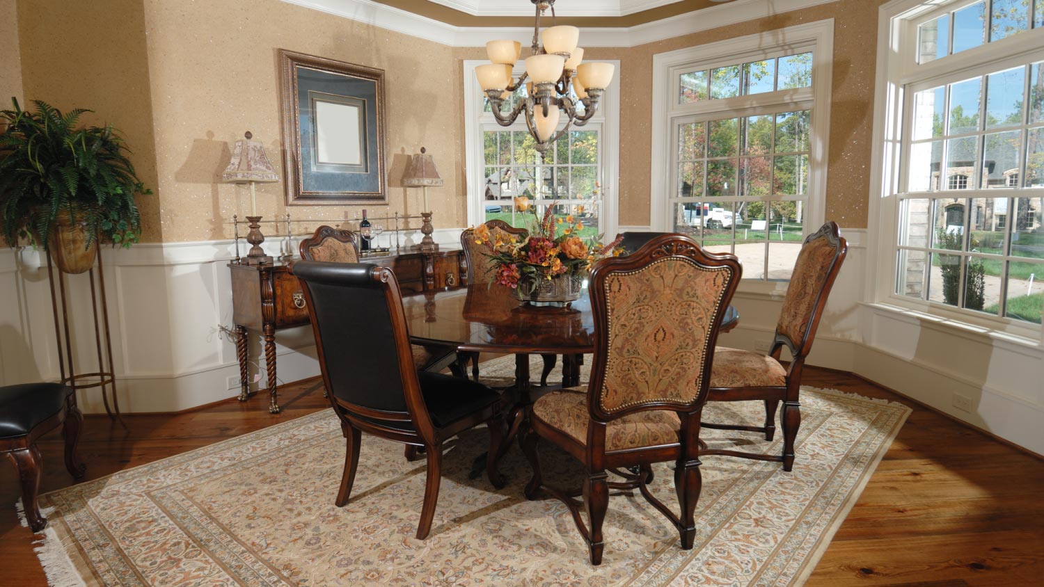 A dining area with queen anne chairs