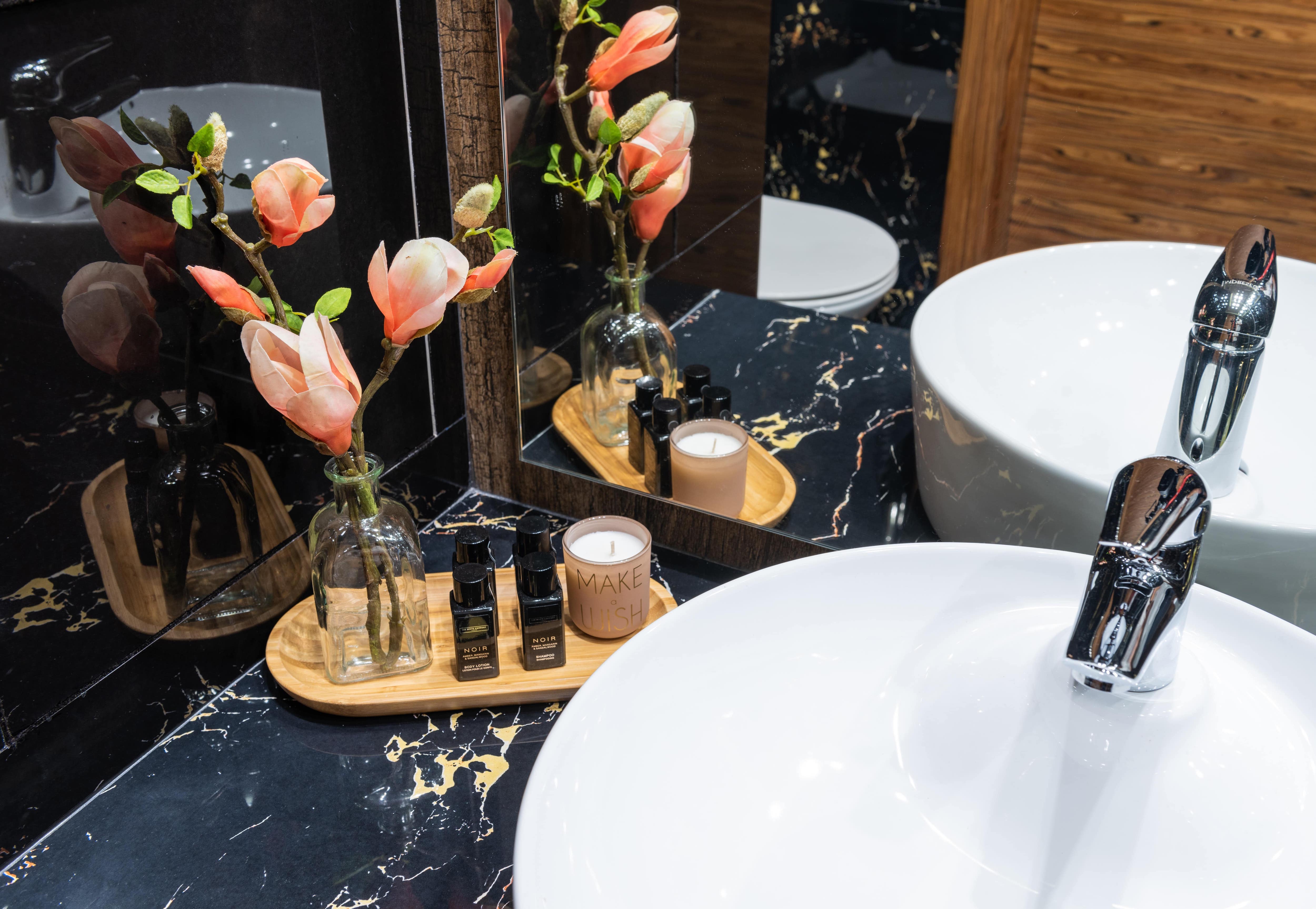 Black bathroom countertops with wooden tray