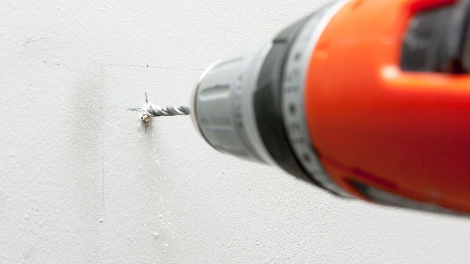 Drilling hole in a wall with electric drill