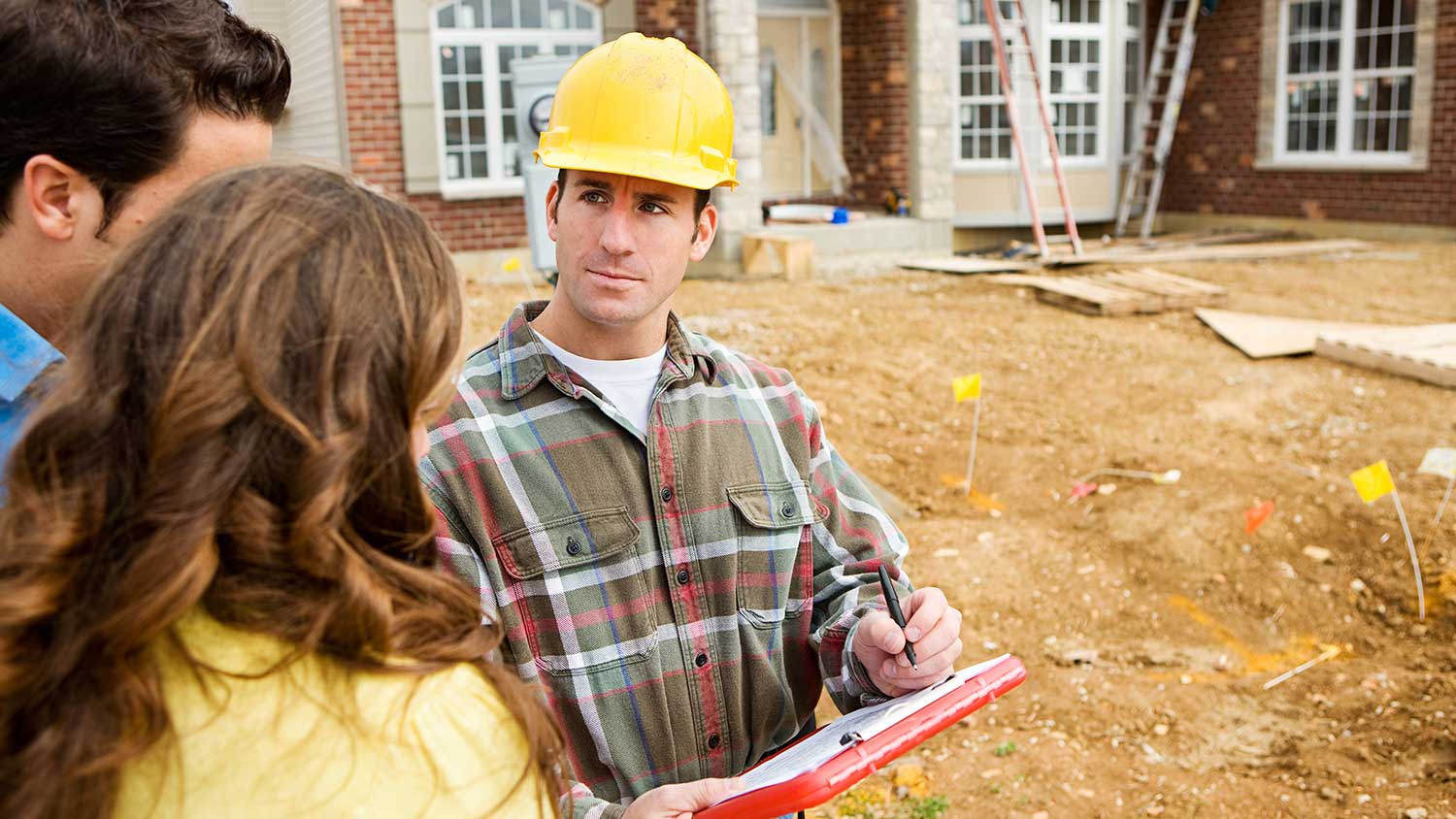 Engineer reviewing plans with homeowners