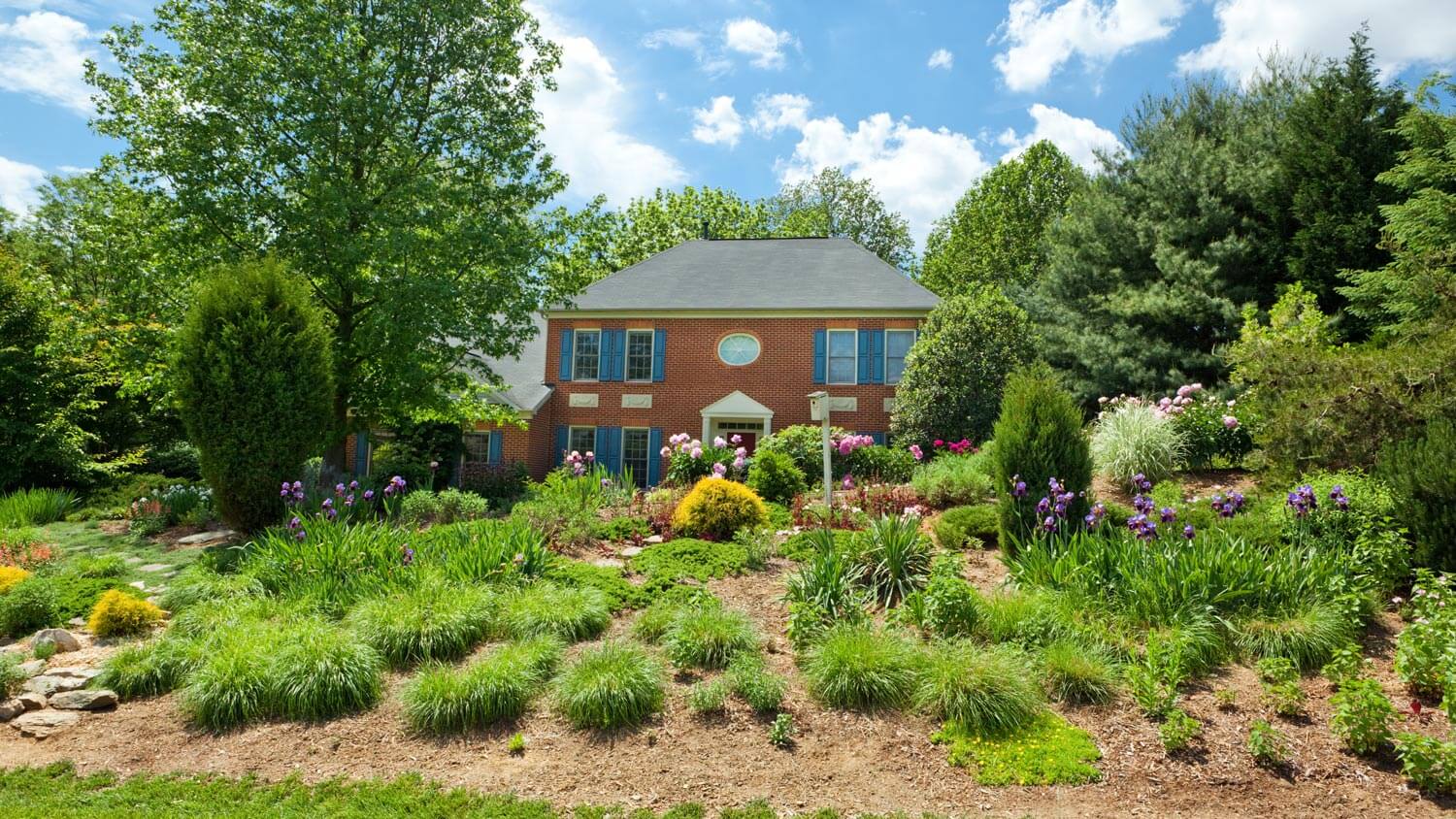 The exterior of a house with the garden having a berm