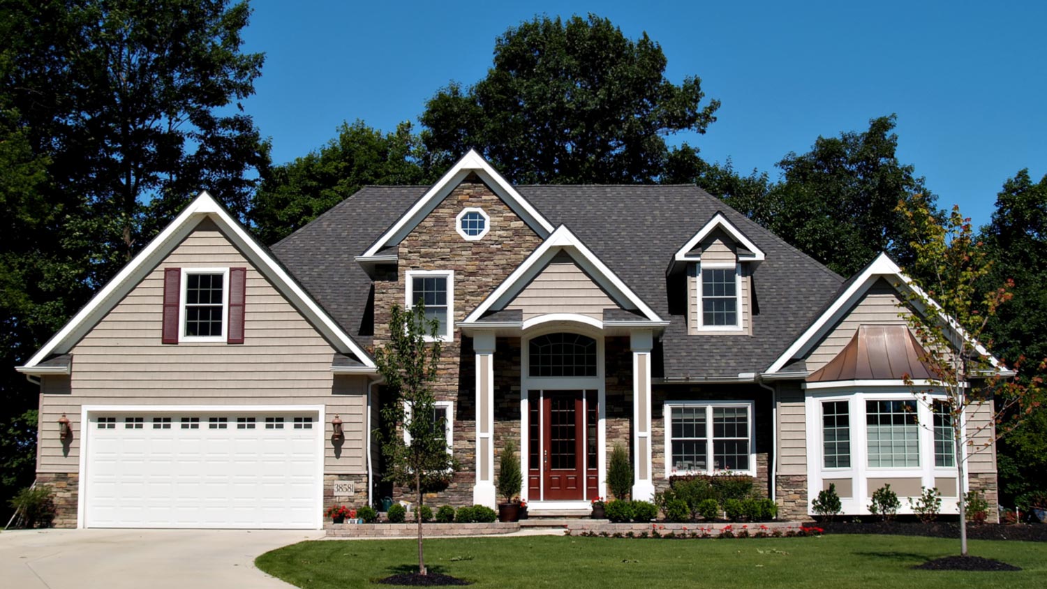 The exterior of a large home with a beautiful garden