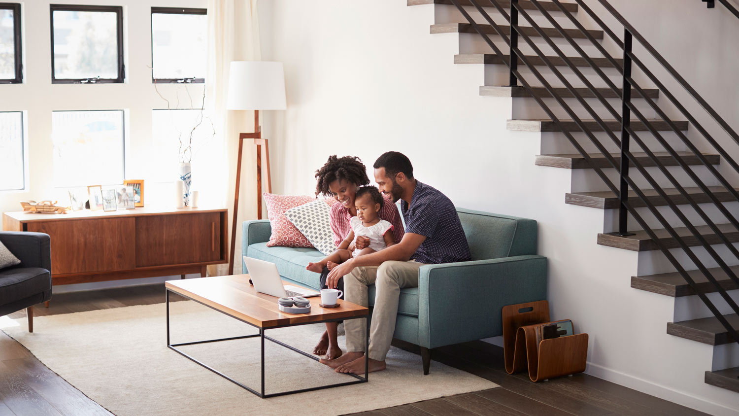 A family of three talking to someone on the laptop