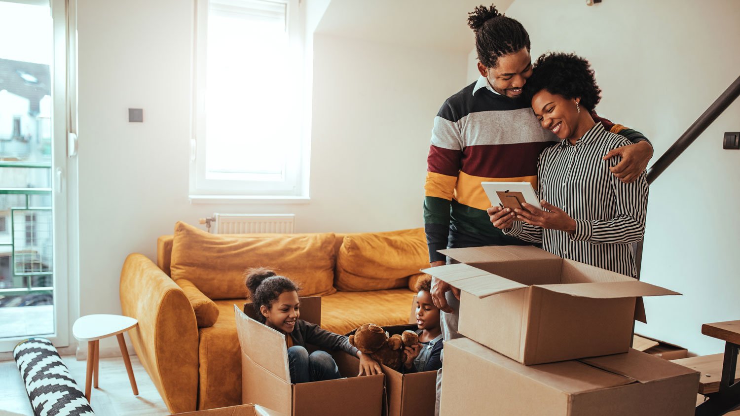 A family packing cardboard boxes
