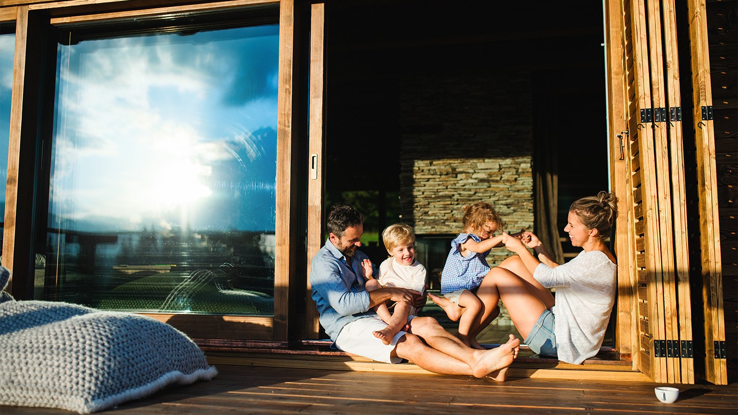 family sitting outside on their wood patio