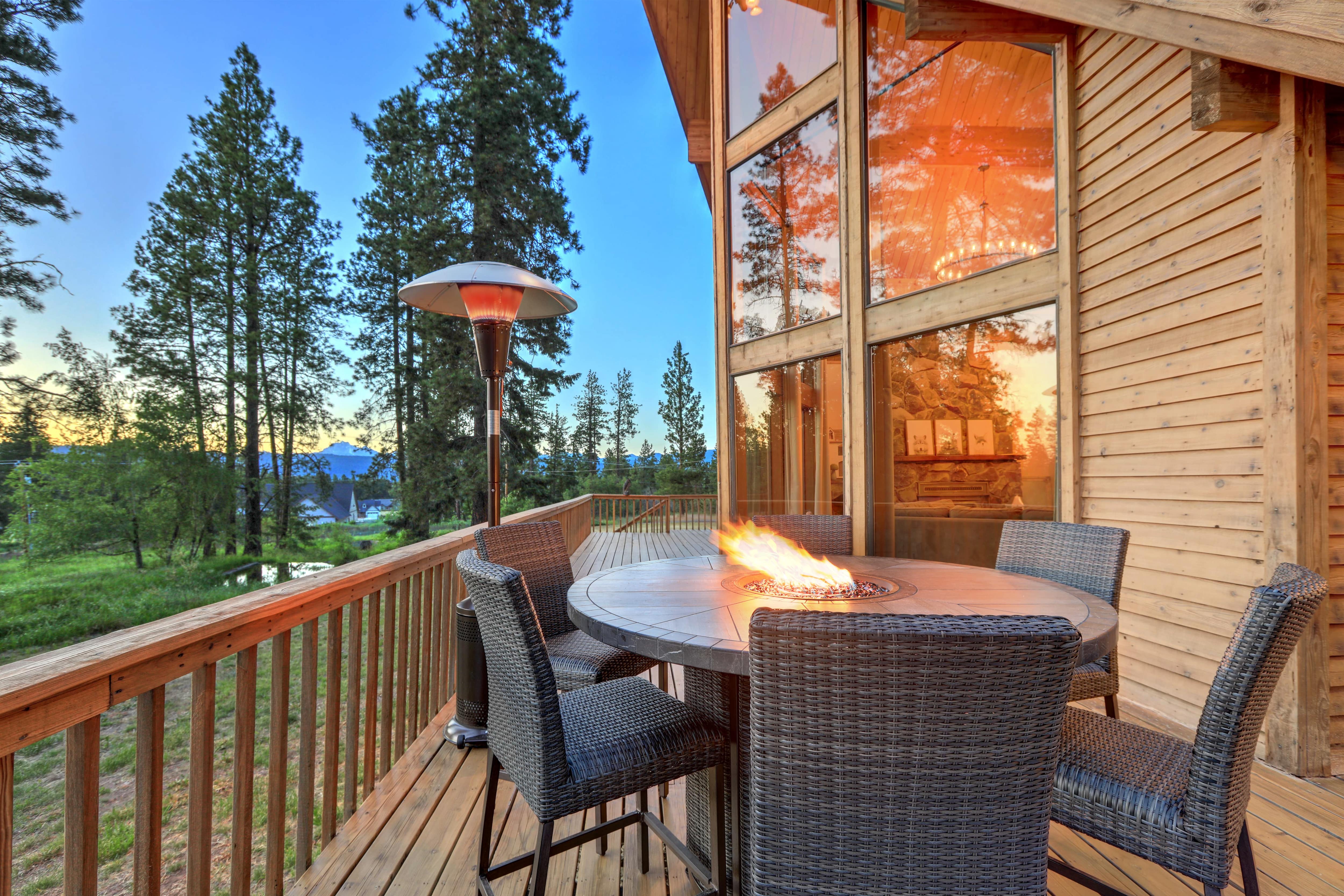 A high top table with a built-in fire pit on a luxury balcony