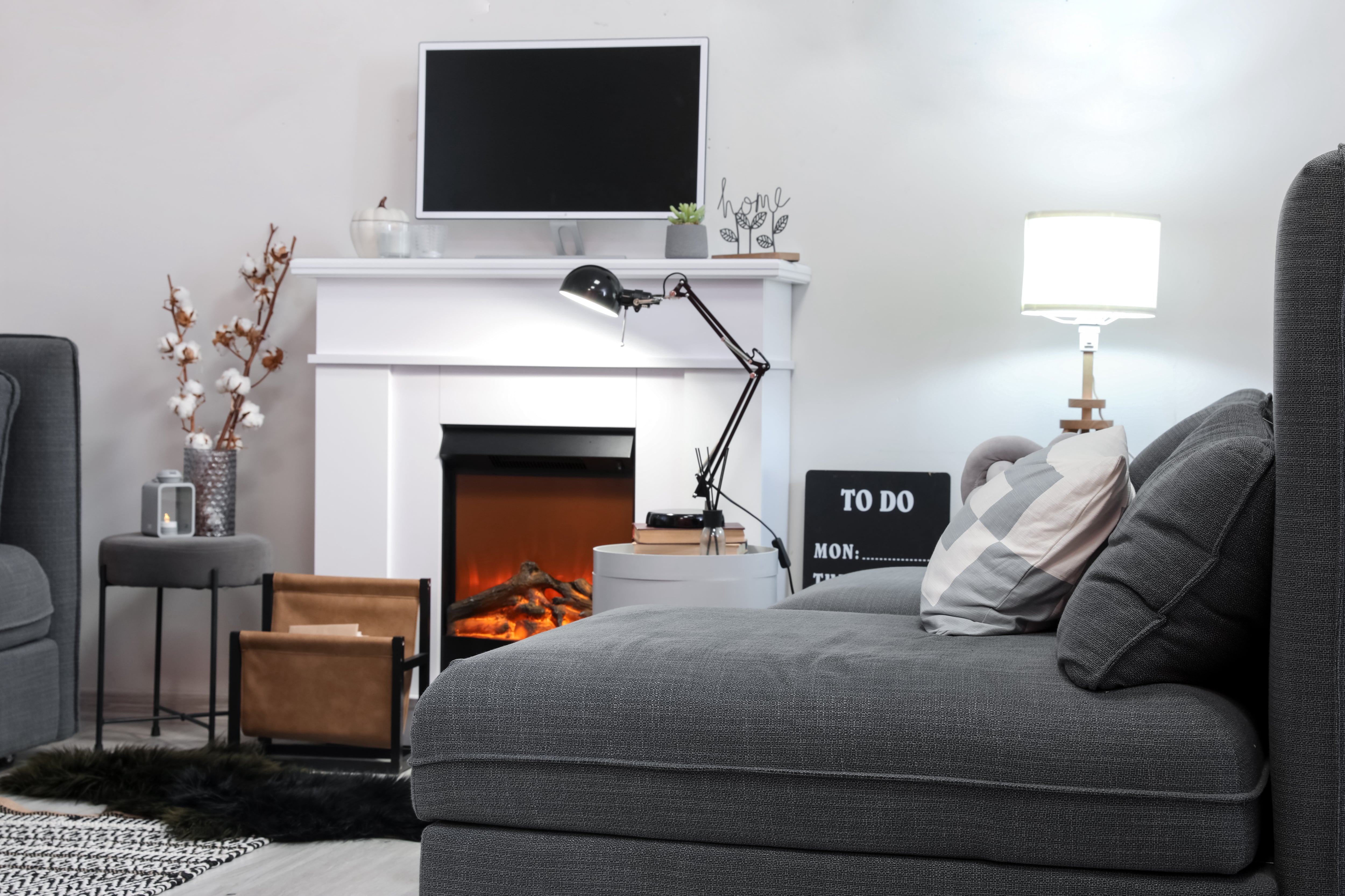 Gray couch, fireplace, and TV