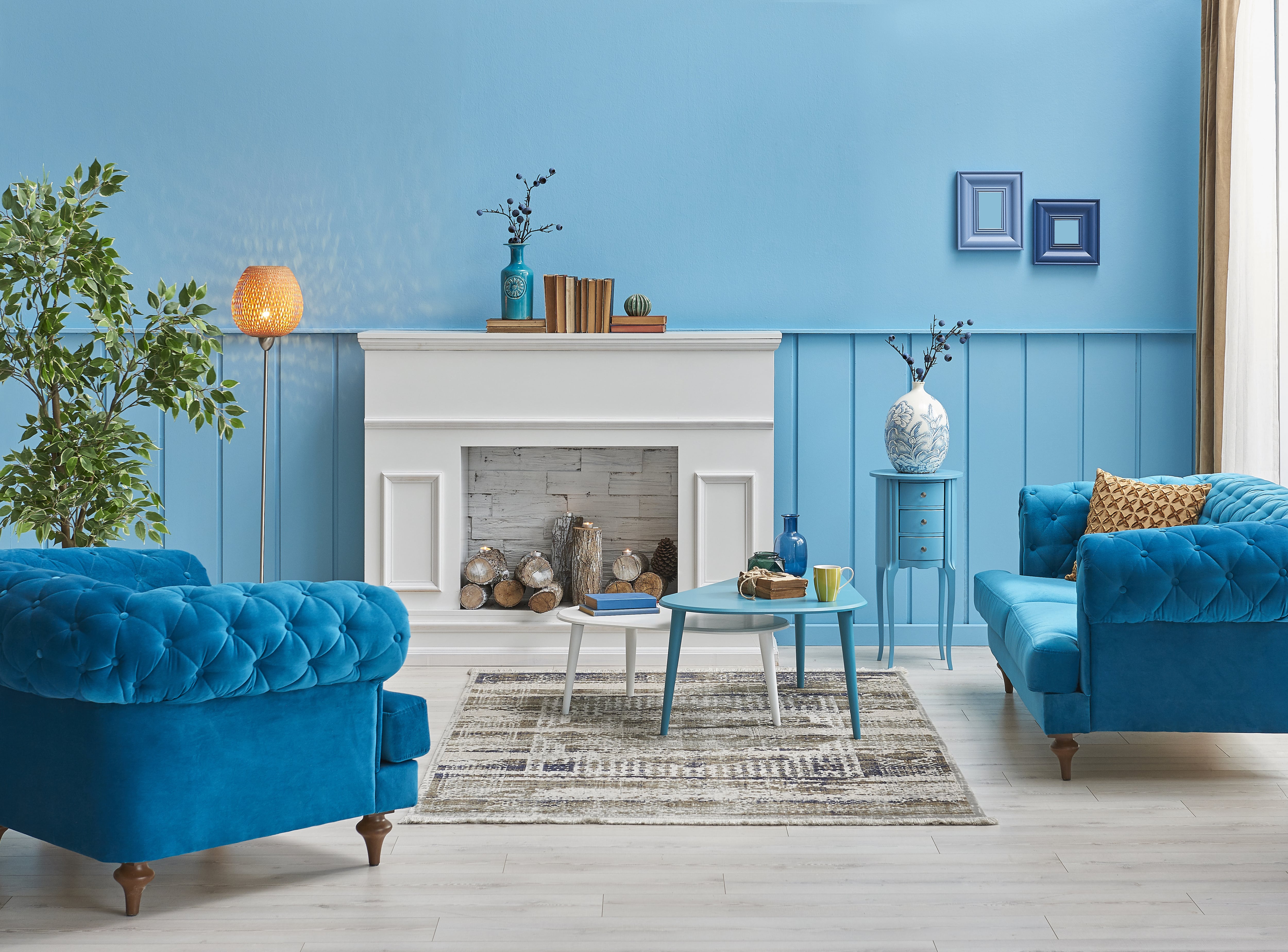 White fireplace against blue wall 