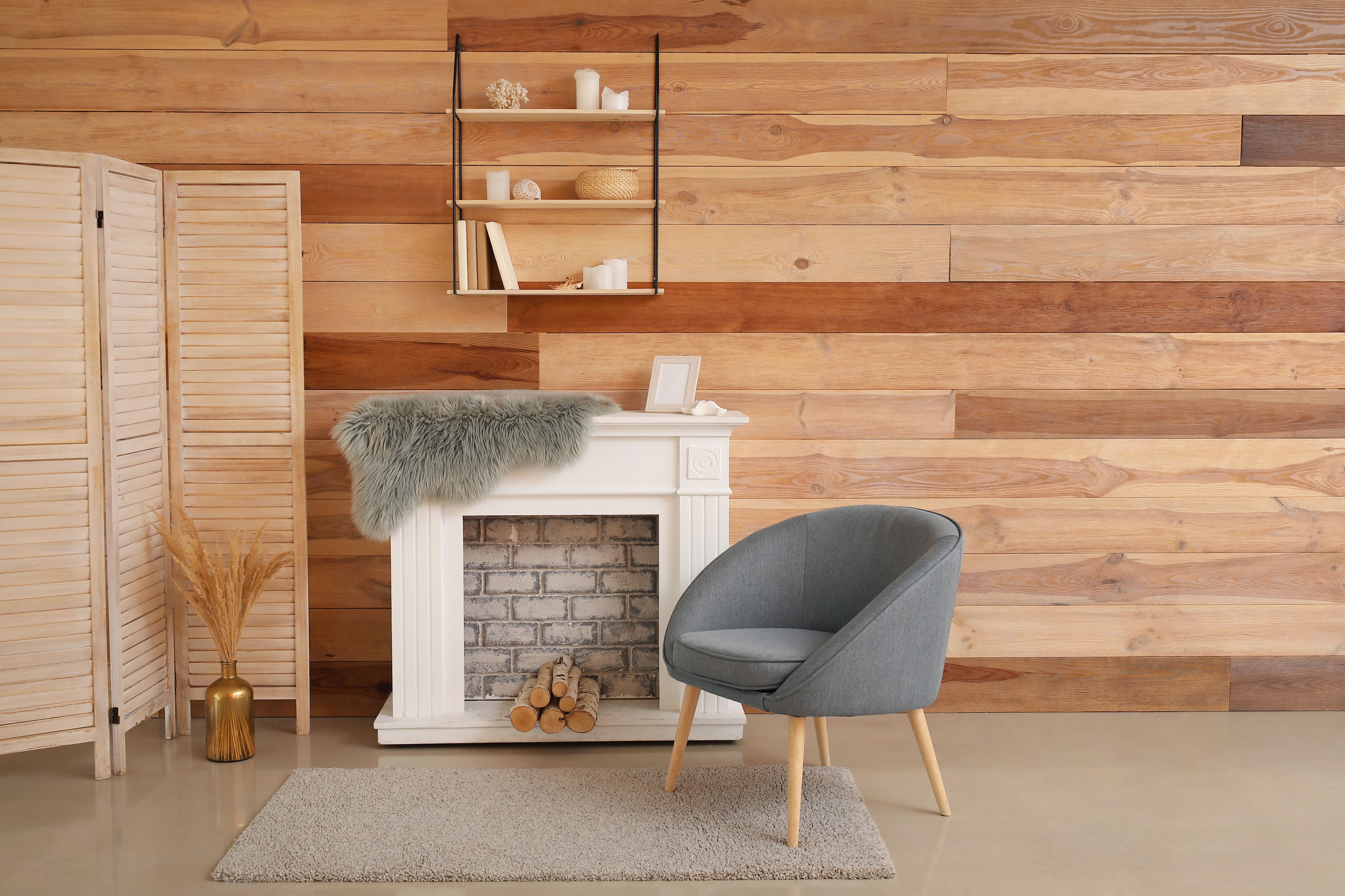 White fireplace mantel with gray fur draped on top 