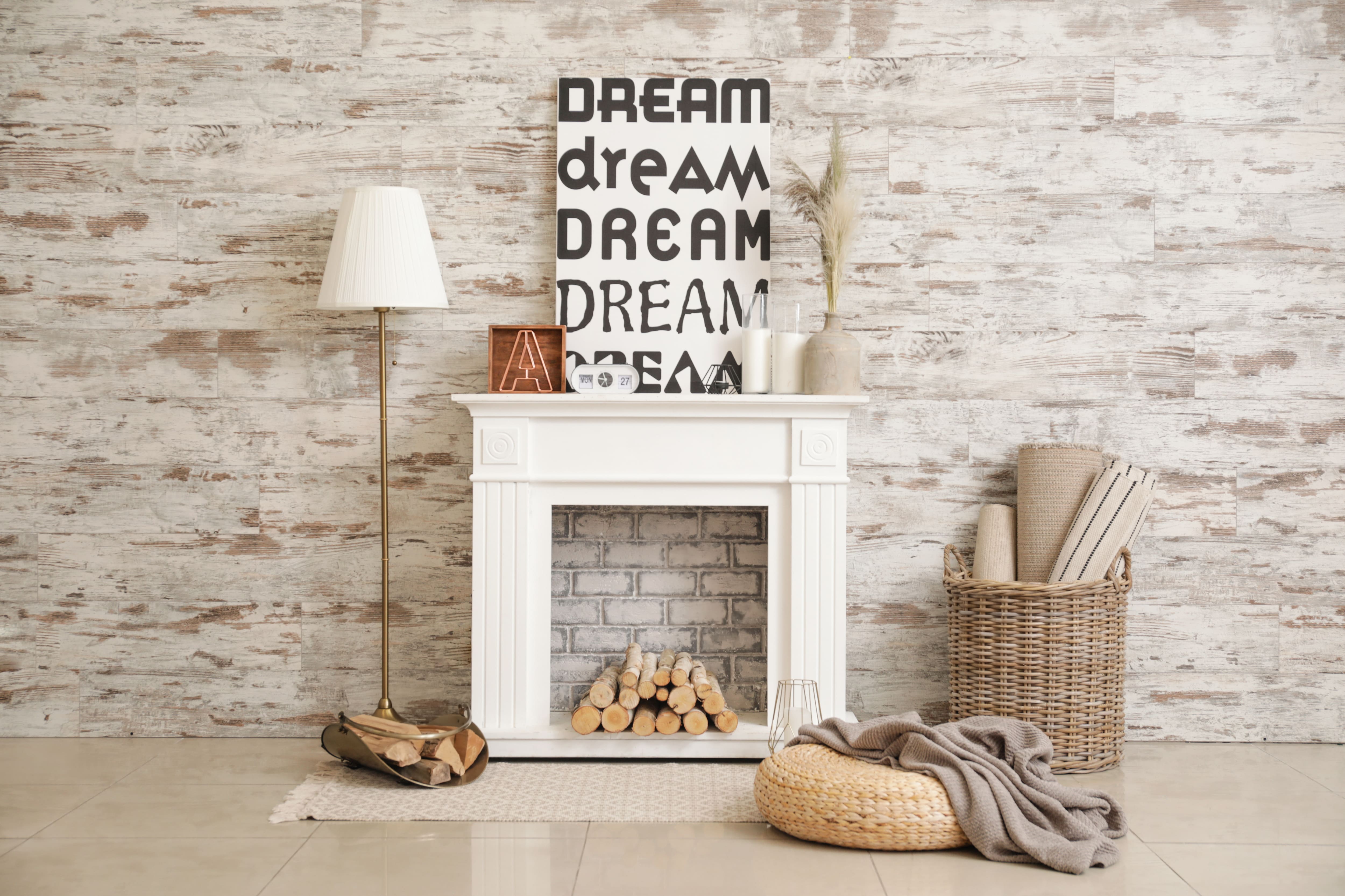 Fireplace mantel decorated with artwork that says “dream” 