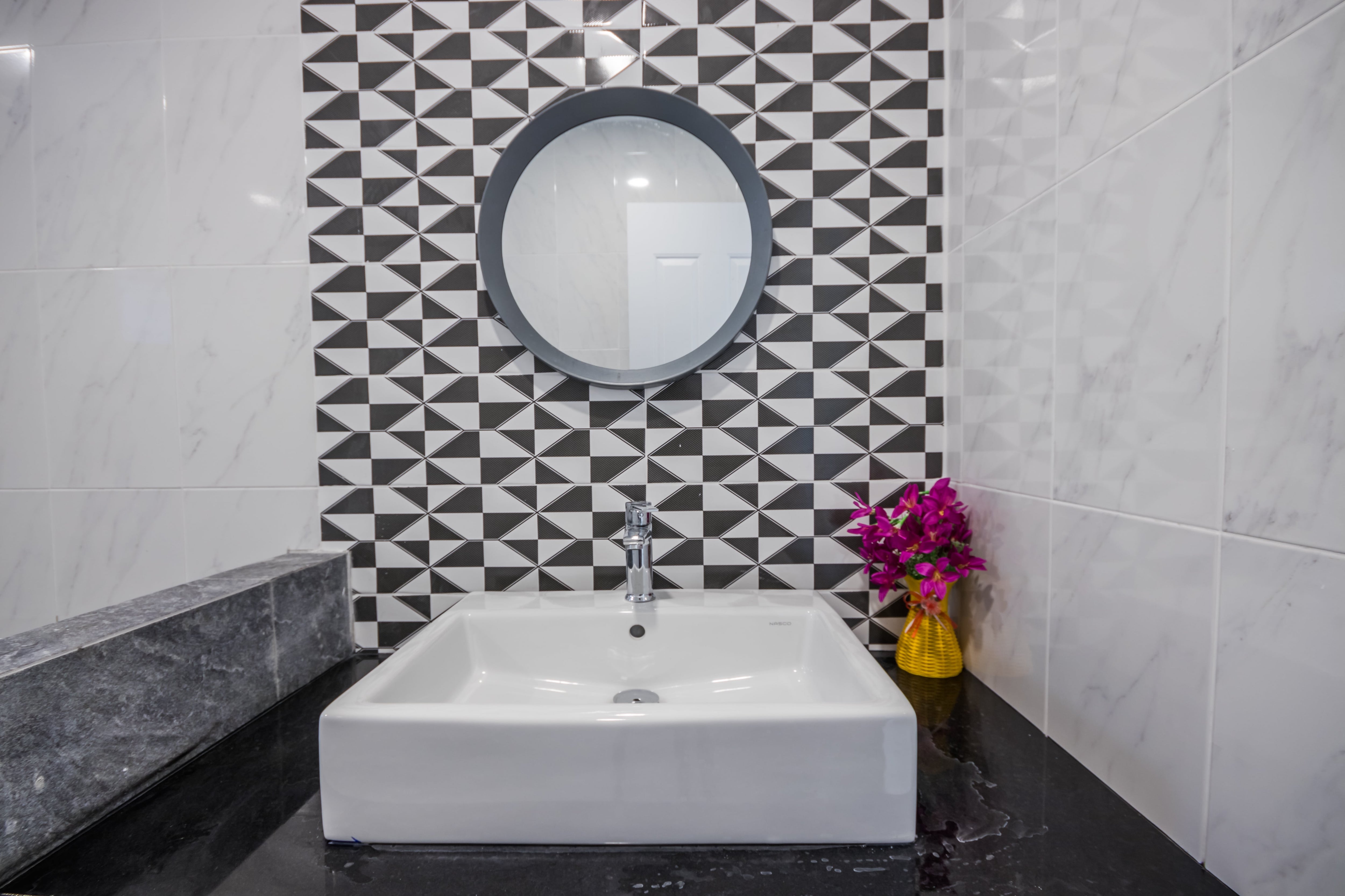 Black and white accent wall in small bathroom