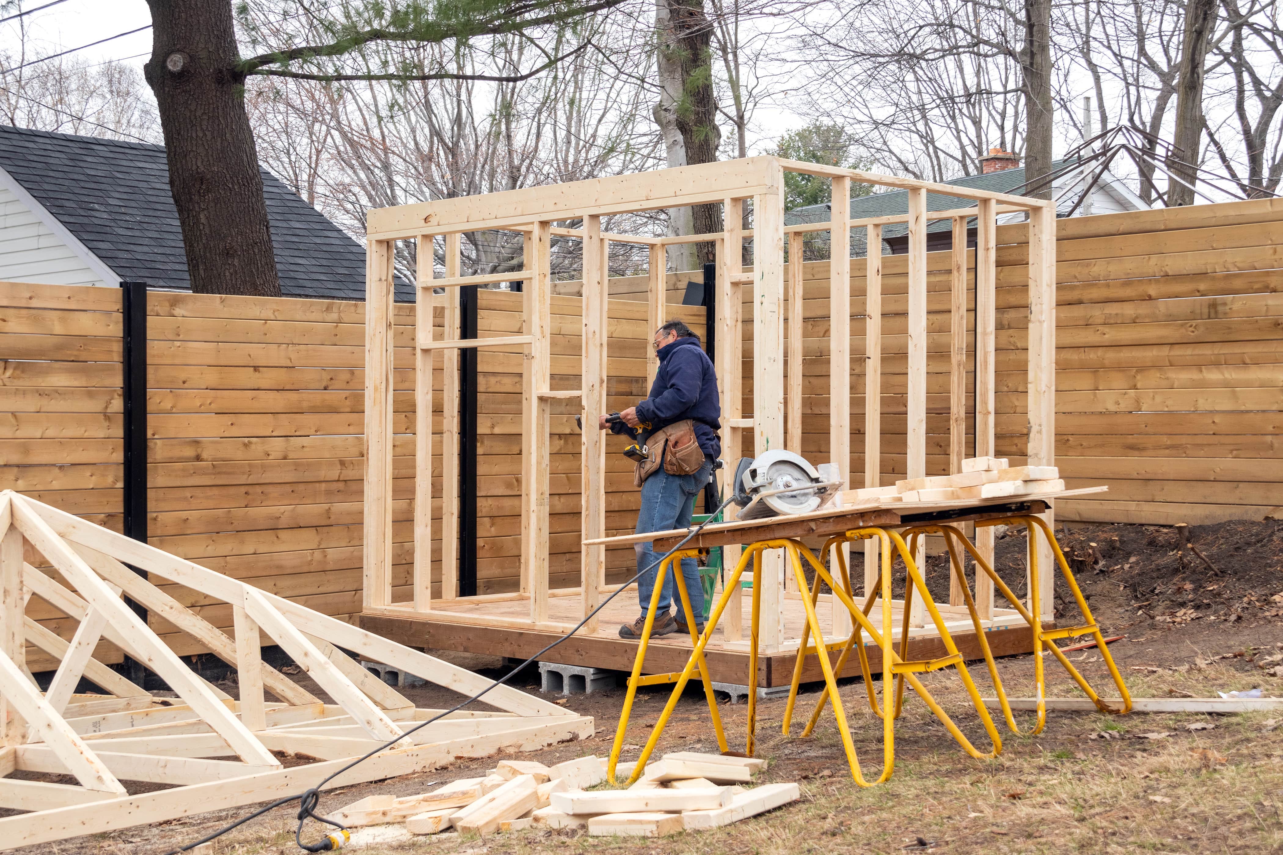 A carpenter building wall frames