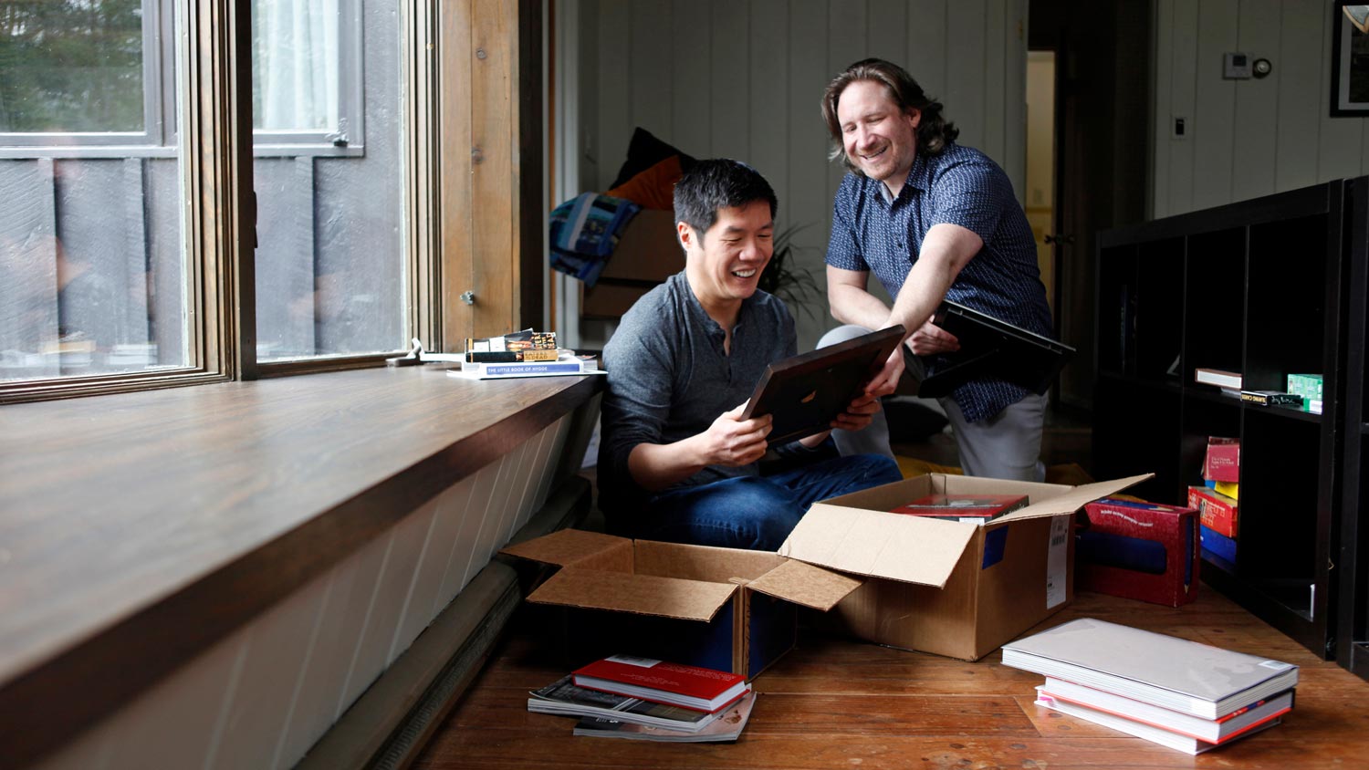 Two friends packing boxes