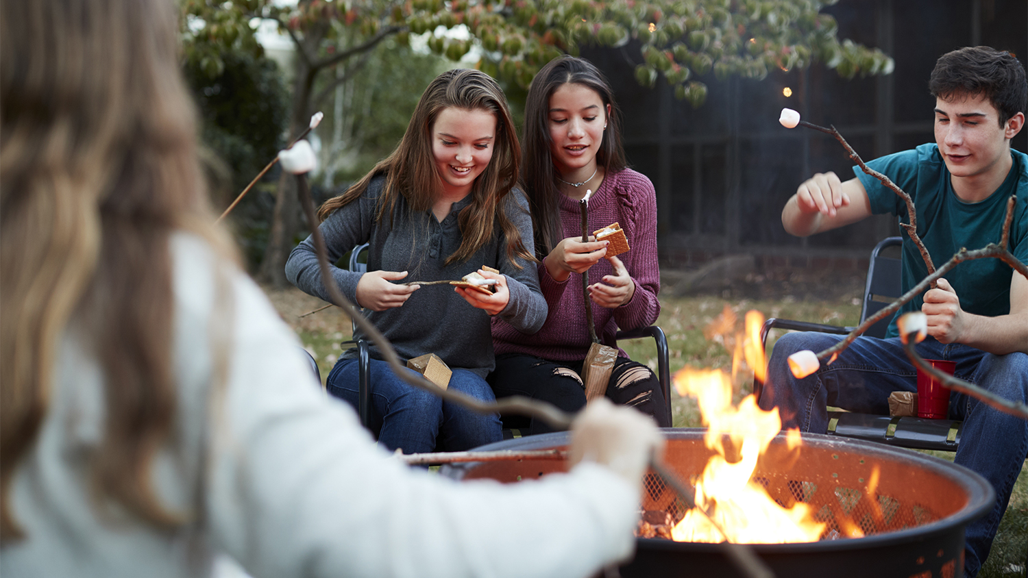 friends making smores at firepit