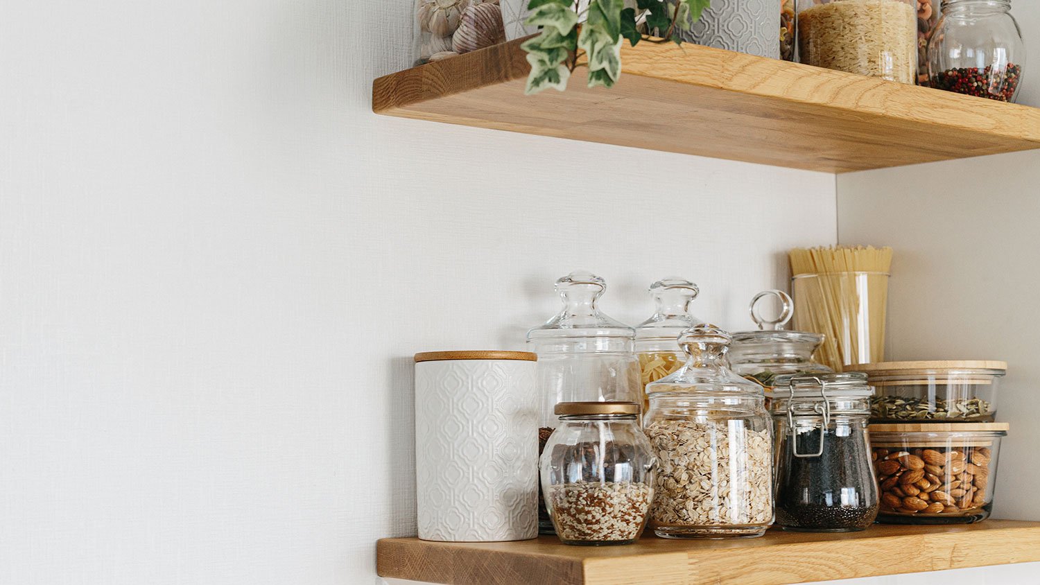 Glass jars with seeds on kitchen shelves