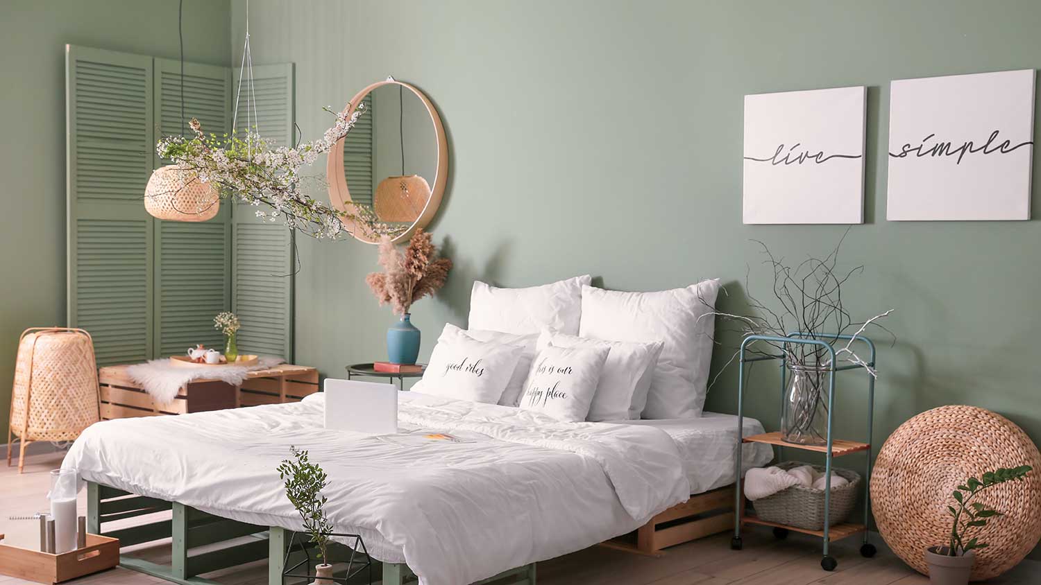 Bedroom with green walls and spring flowers