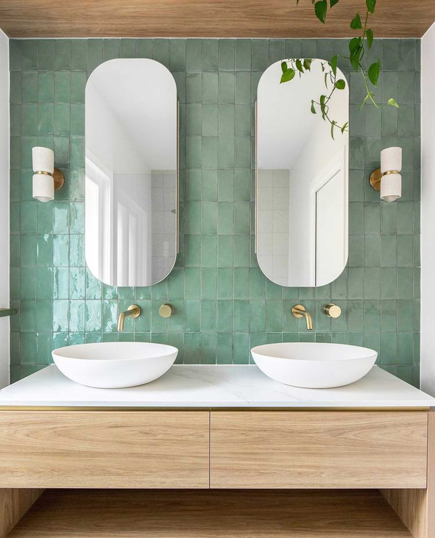 Luxury green tiled bathroom with two mirrors 