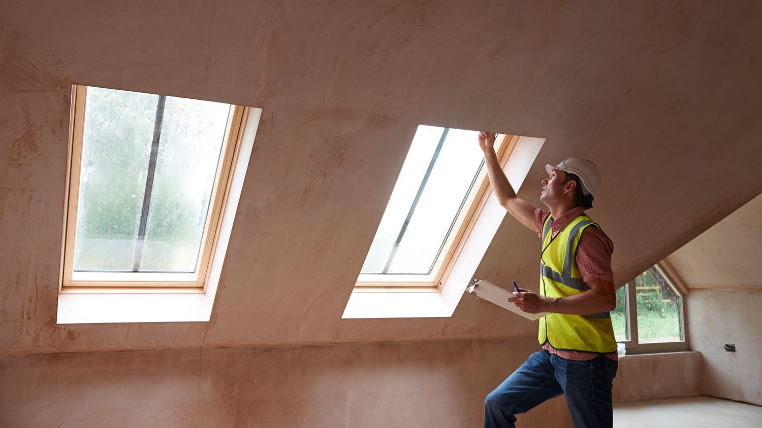 A home inspector checking the windows in the attic