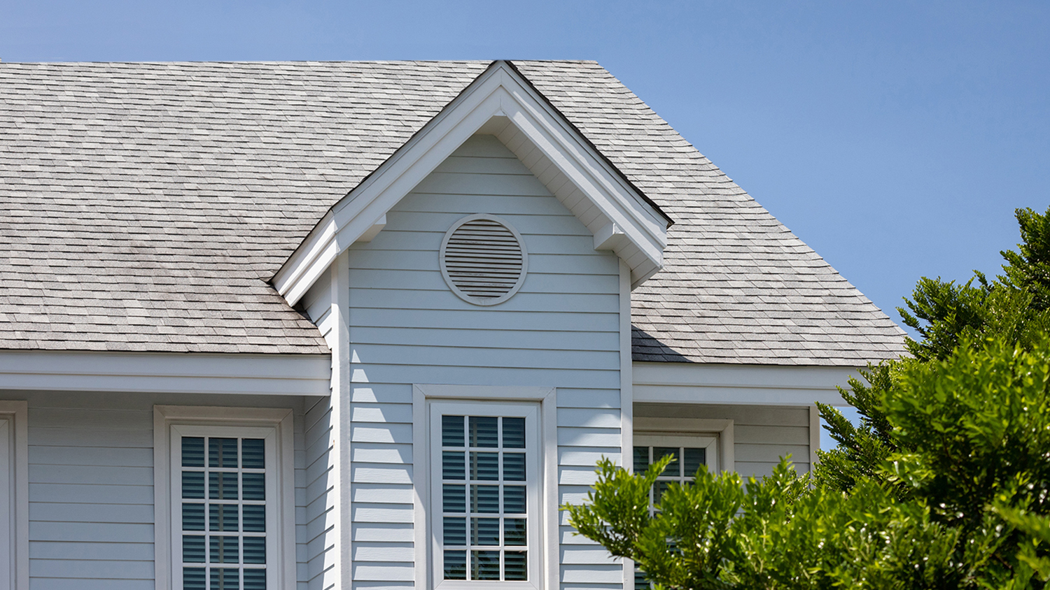 blue home with roof shingles
