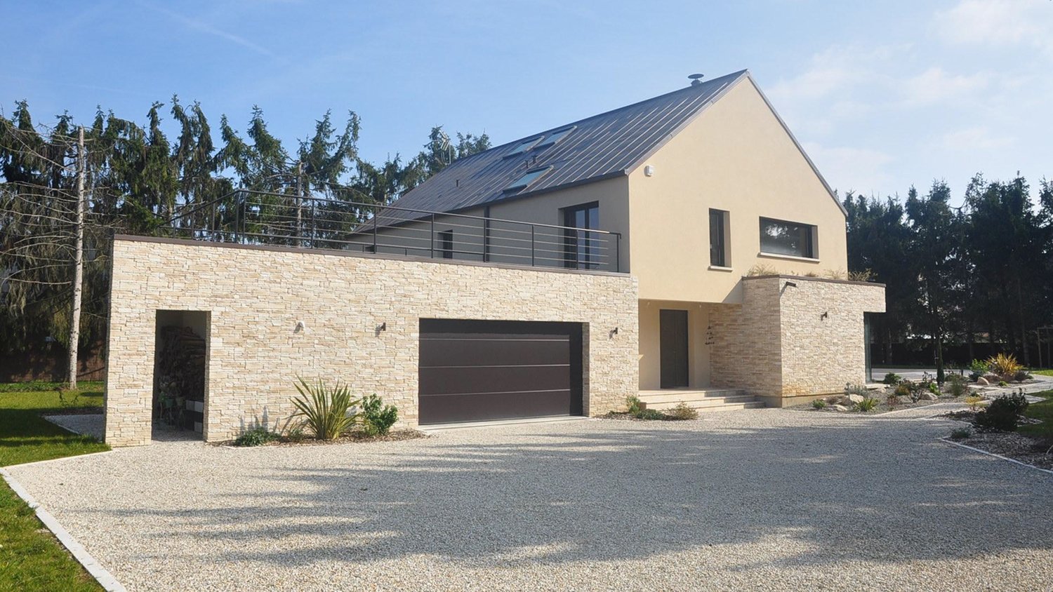 brick home with gravel driveway 