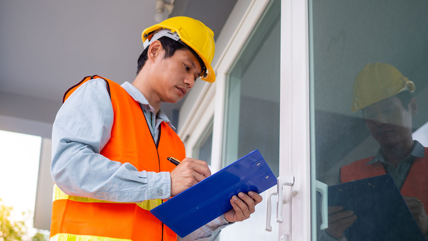 Engineer inspecting the windows in a home