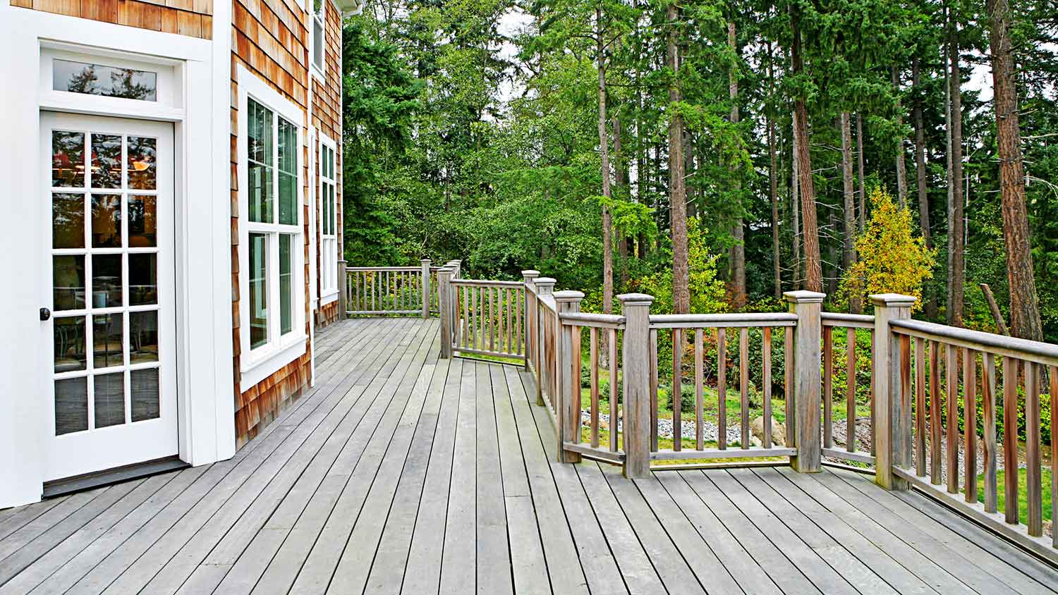 Wooden house with brown roof in the forest