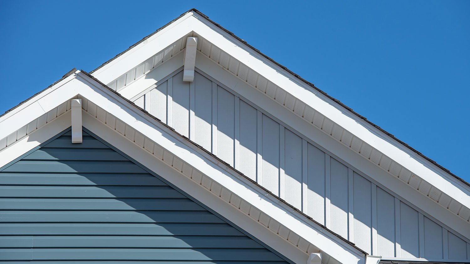 Detail of a house with double gable and vinyl siding