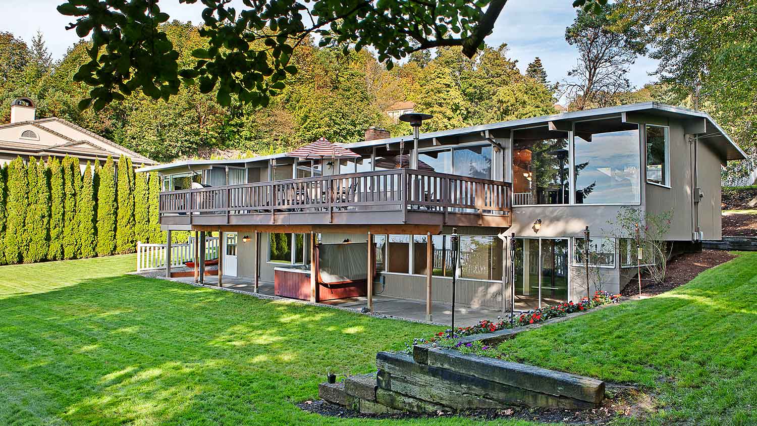 House with elevated deck and large backyard