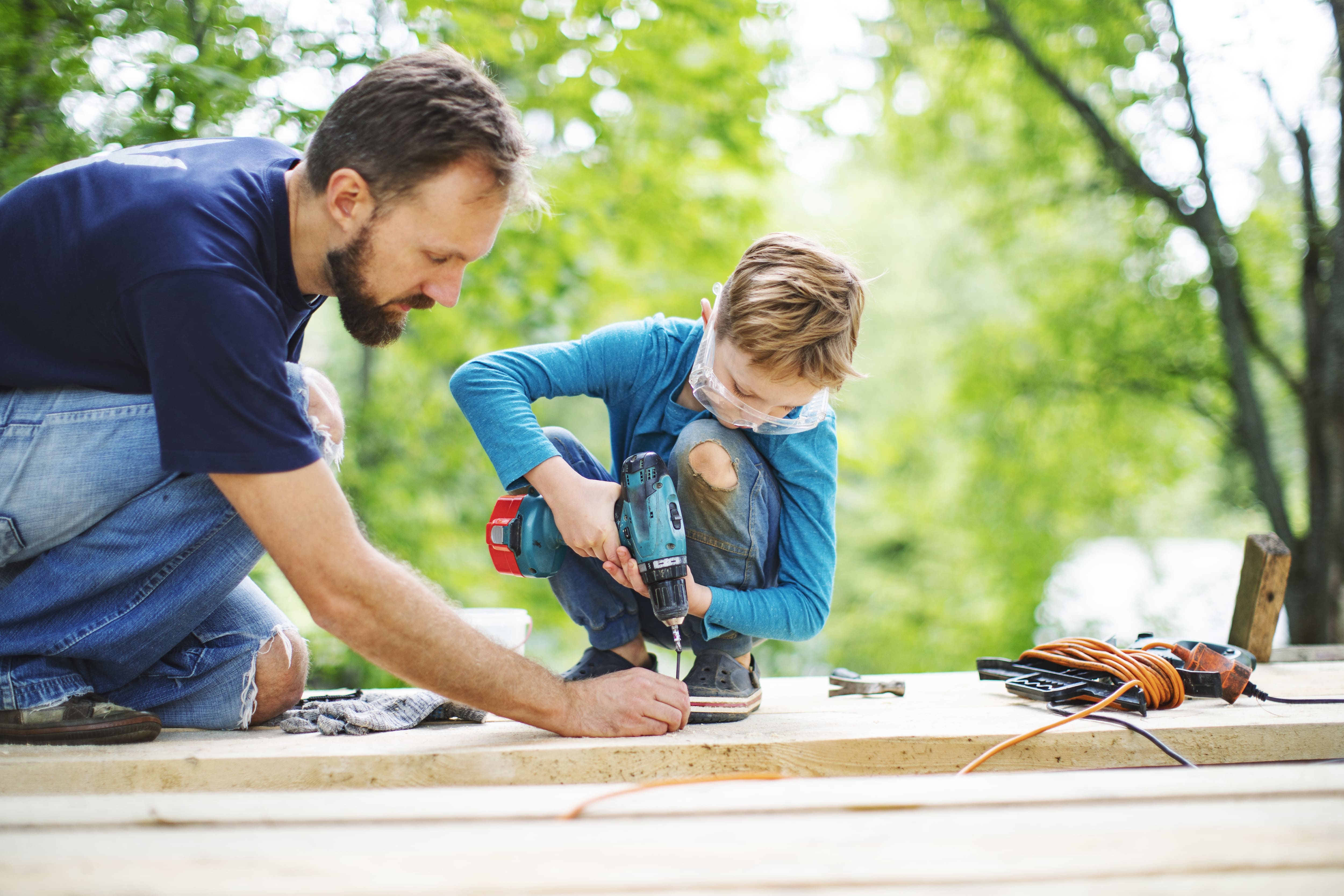 A father and son building a treehouse together