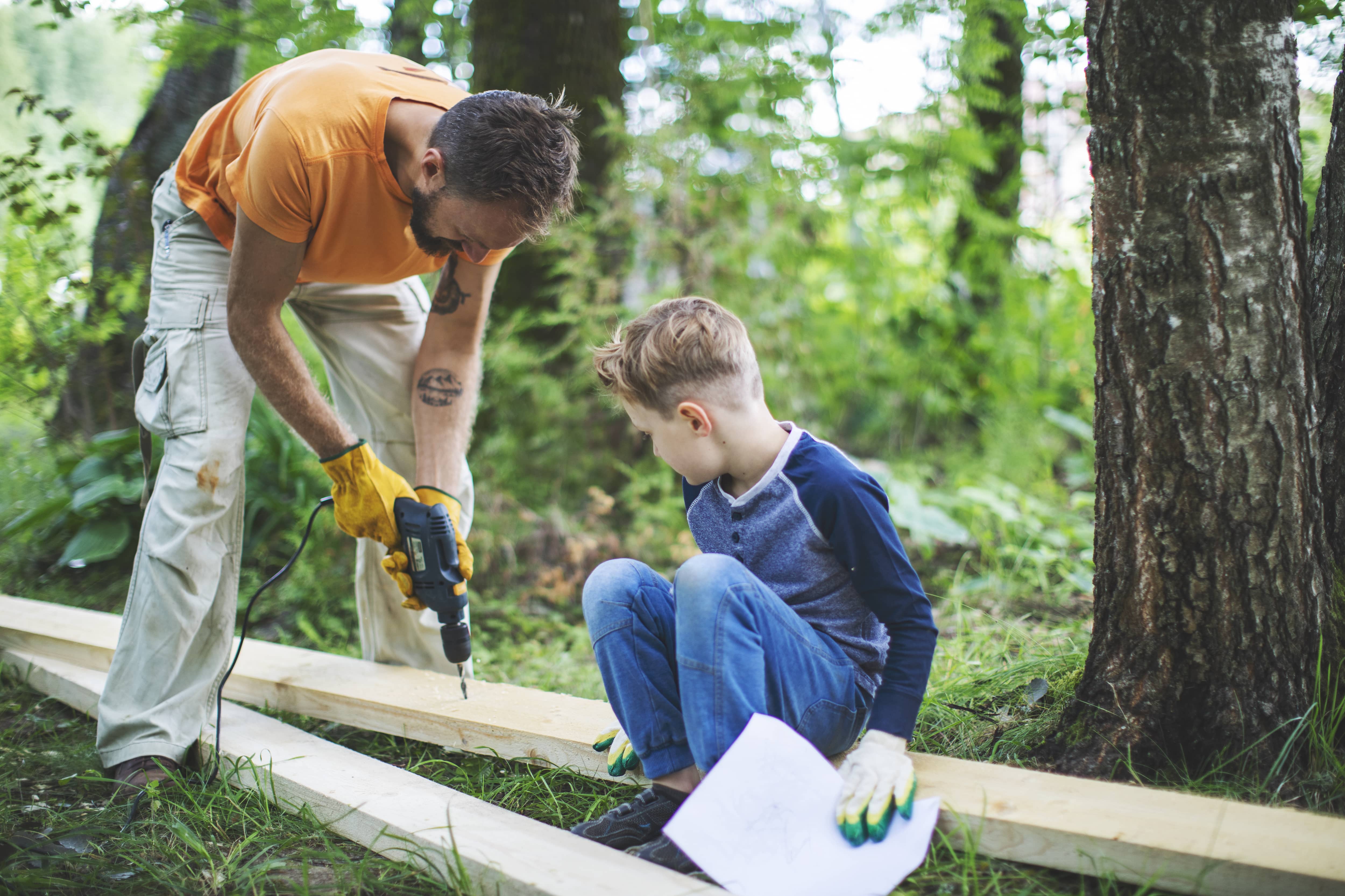 A father and son building a treehouse together