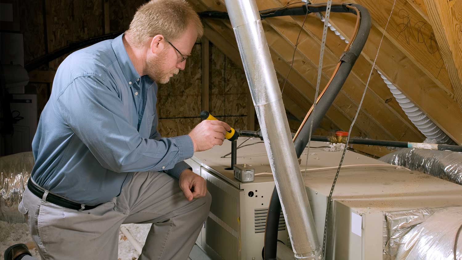 HVAC technician inspecting residential furnace