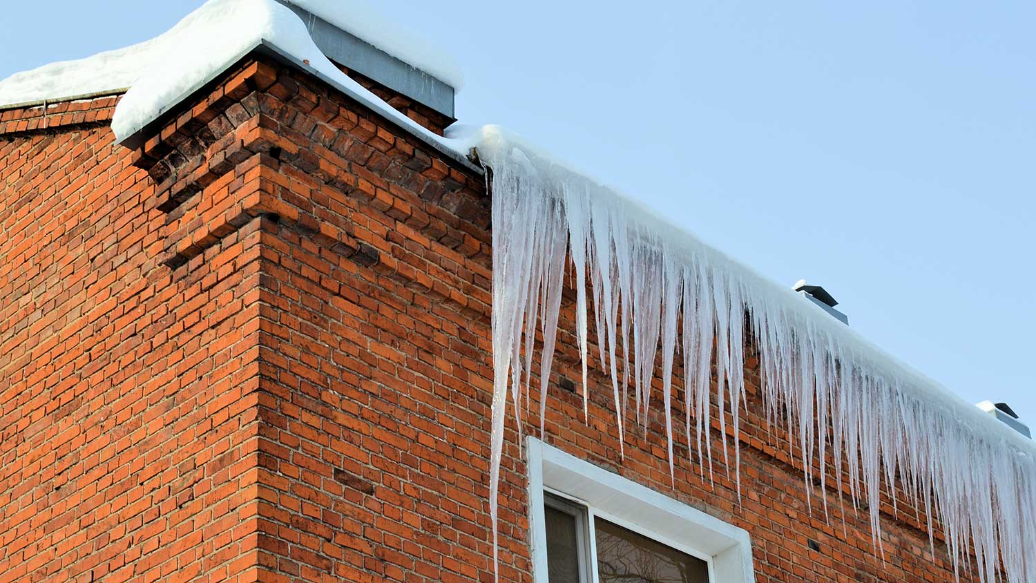 Ice dam on a brick house roof