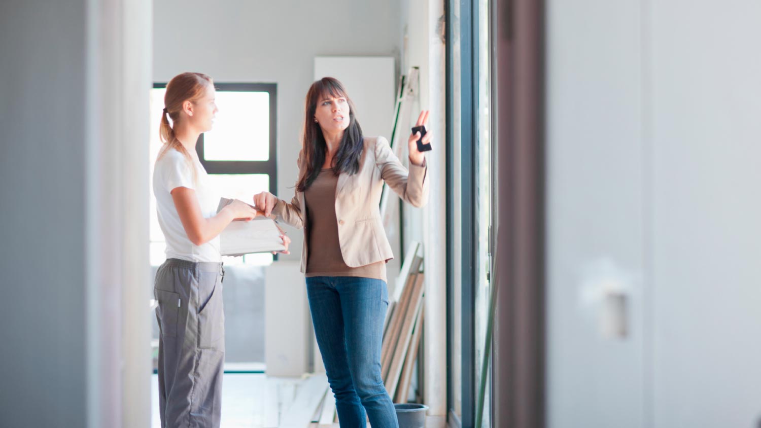 An interior designer and laborer discussing project