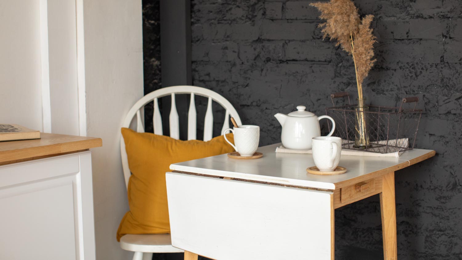 A kitchen interior with folding table and chair