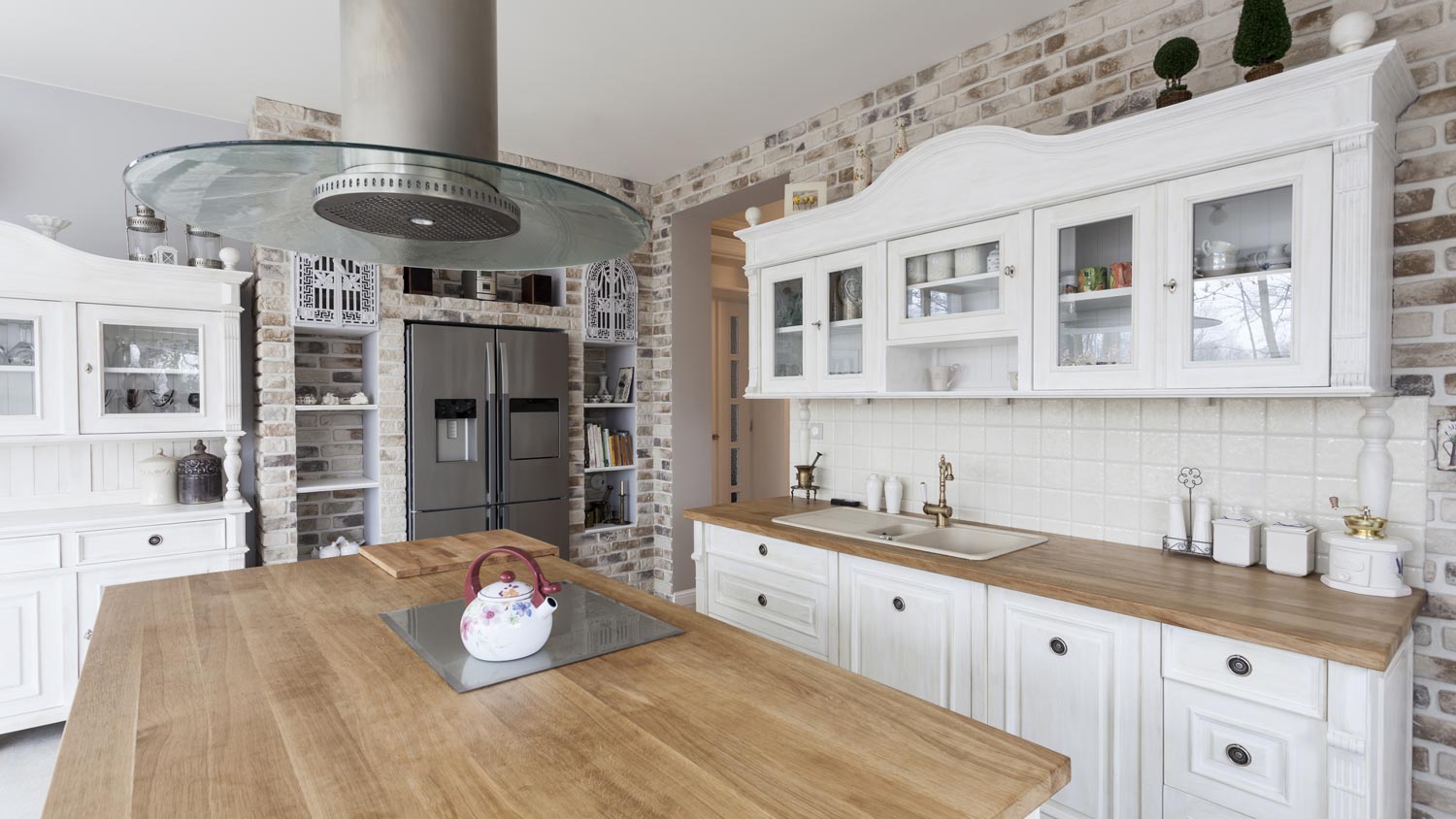 A kitchen with traditional white cabinets