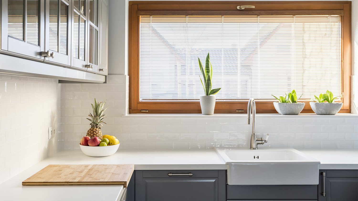 bright kitchen with white countertop and grey cabinets  