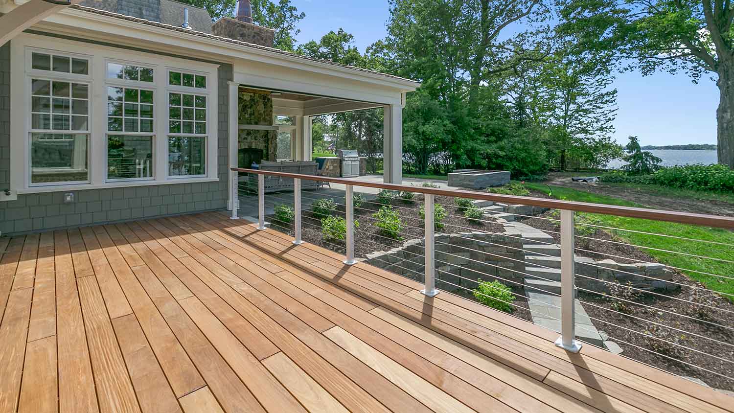 Lake house with large wooden deck