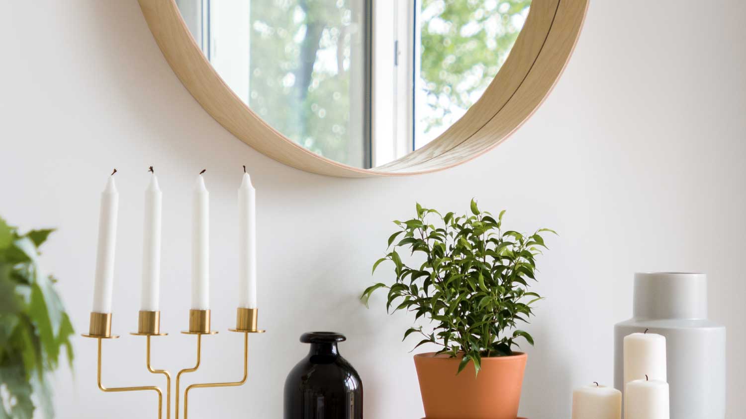 large circle mirror above storage unit