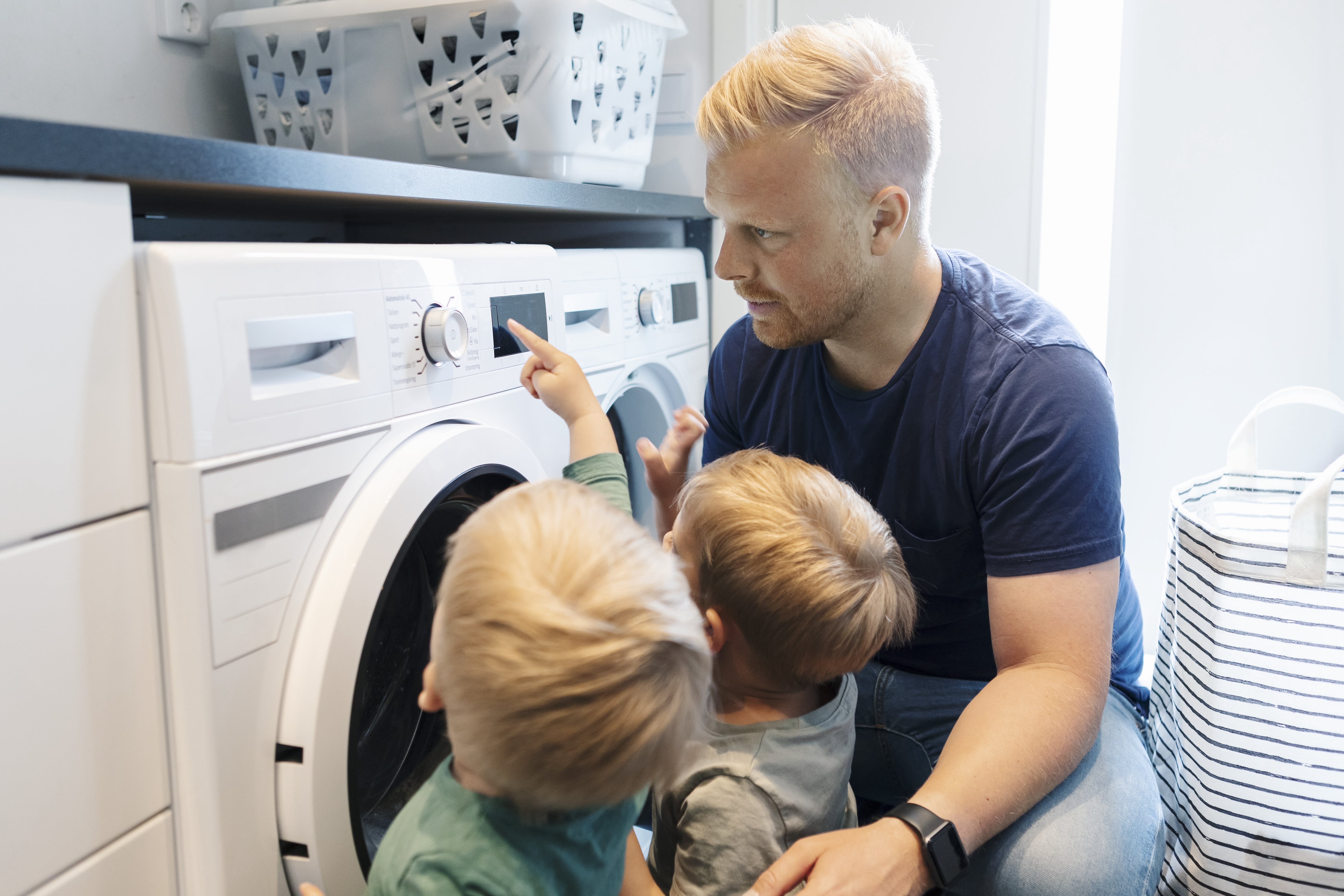 Father and children doing laundry