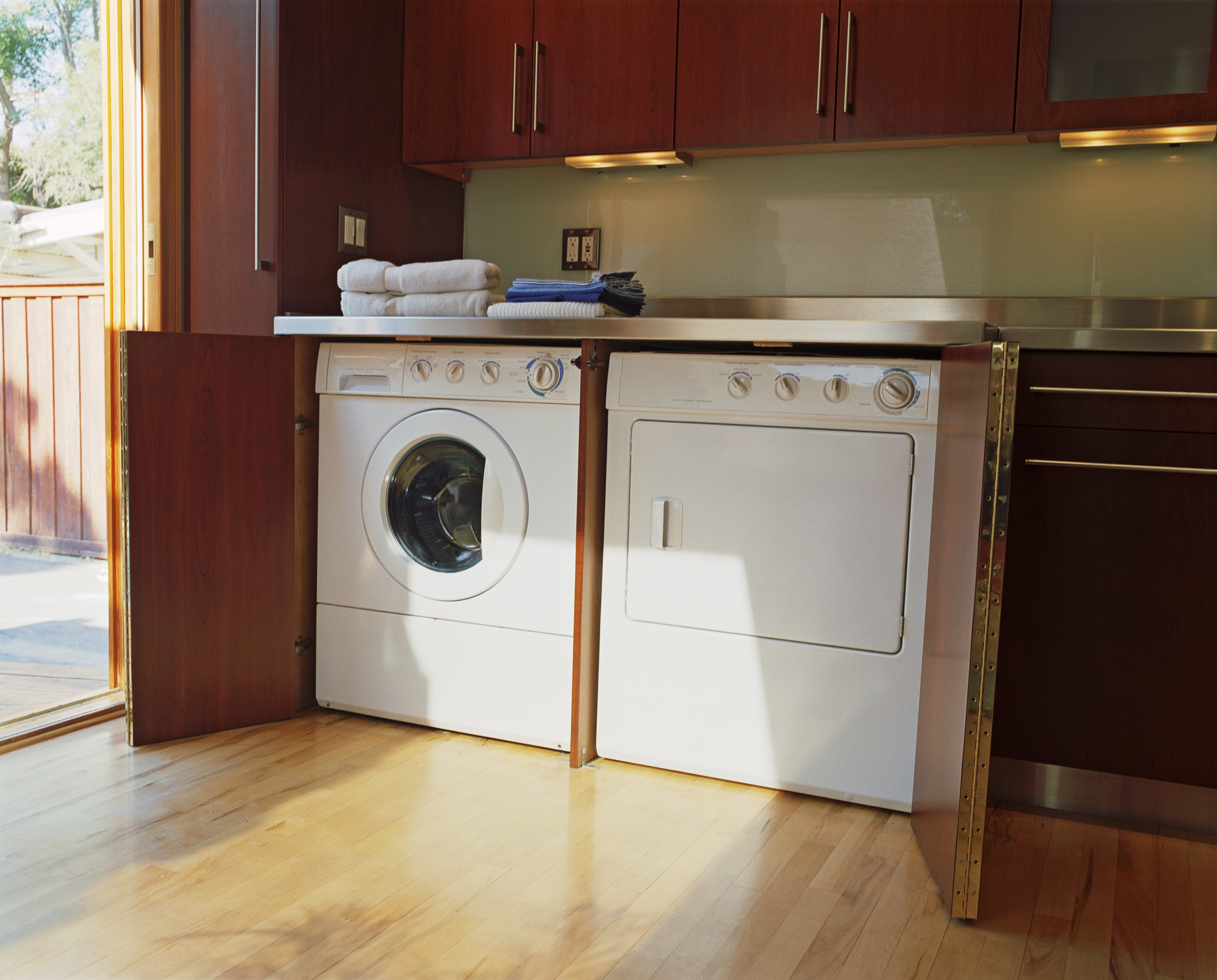 Laundry room with illuminated shelves