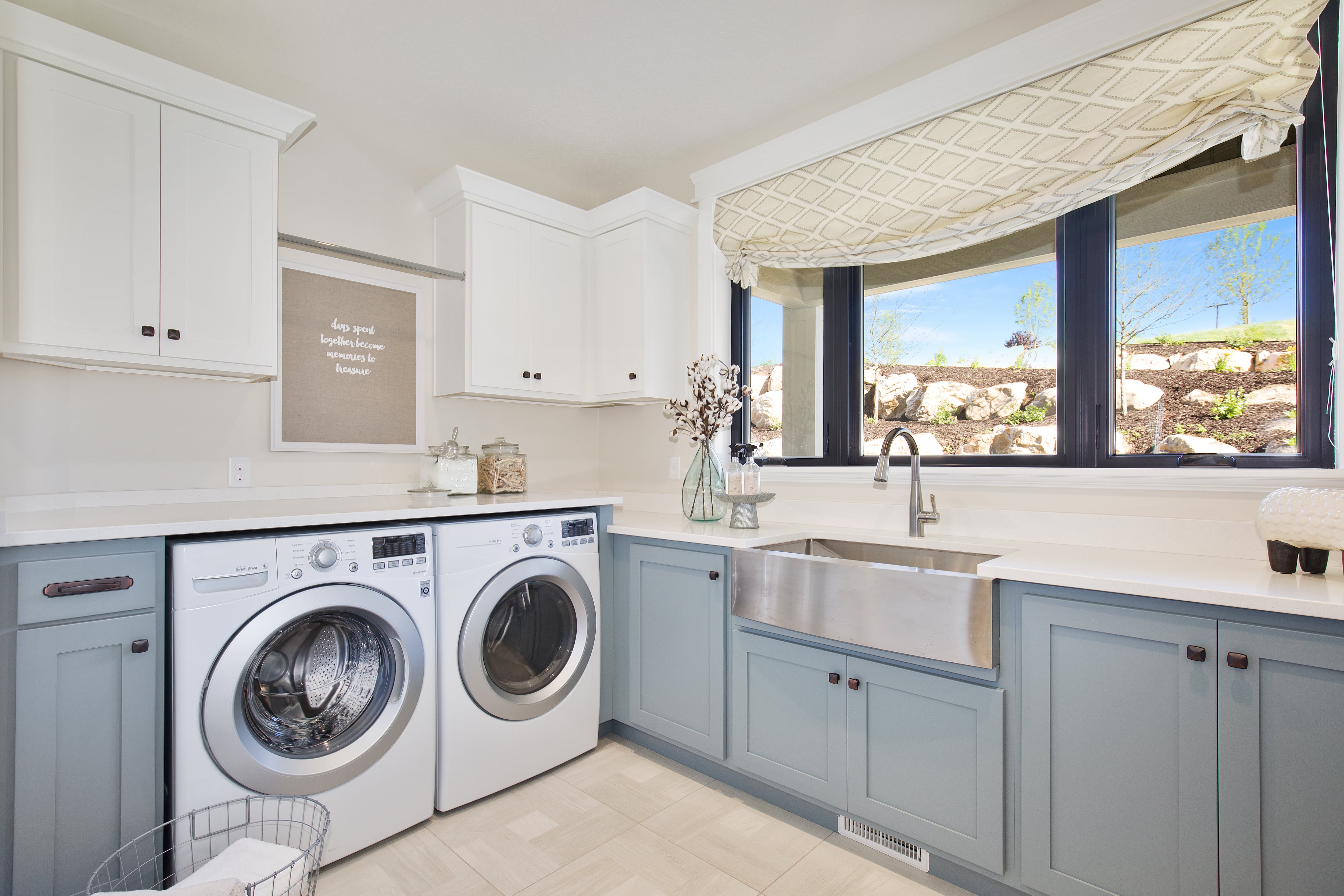 Large laundry room with blue and white cabinetry