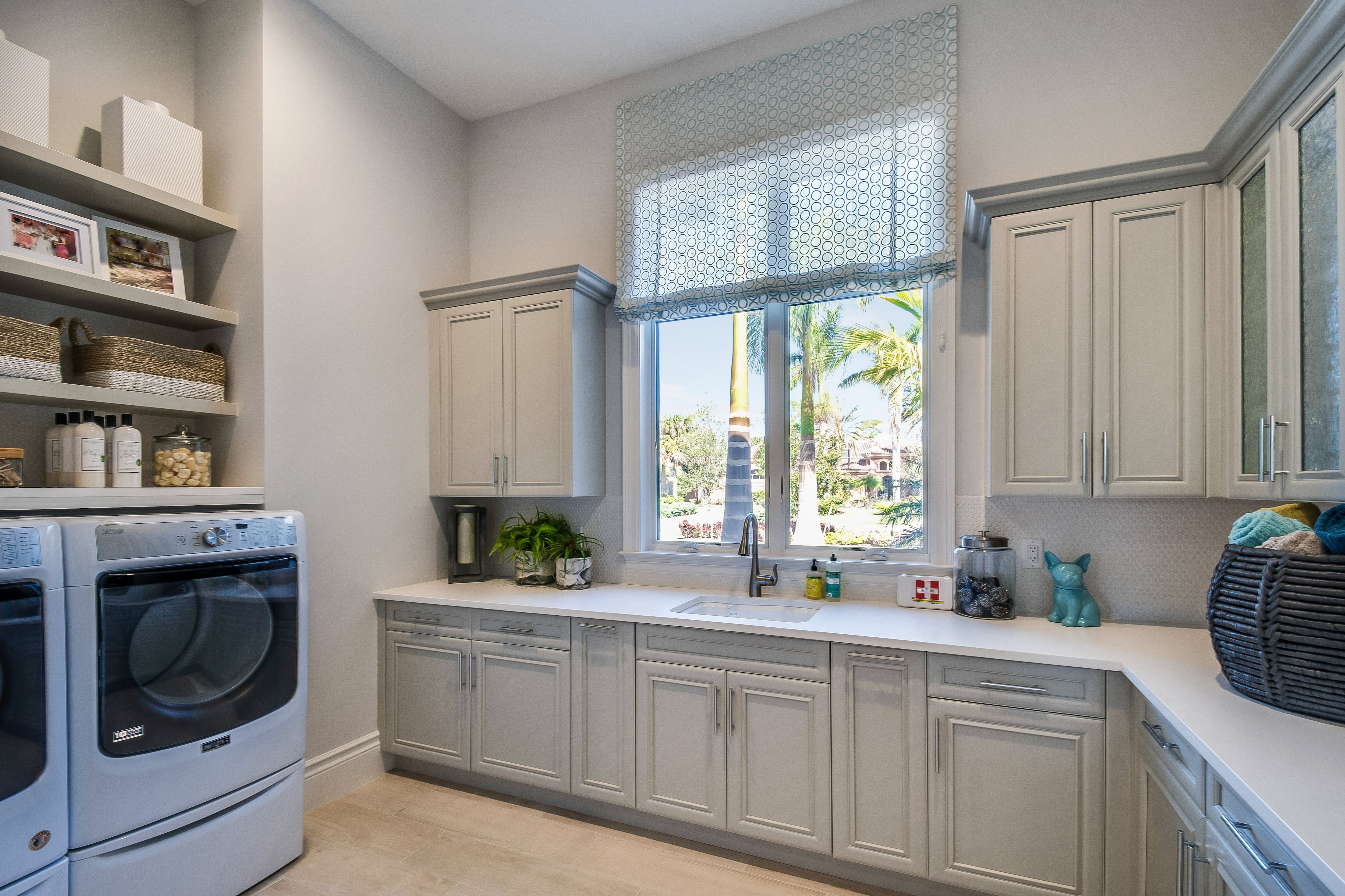 Large laundry room with gray cabinetry