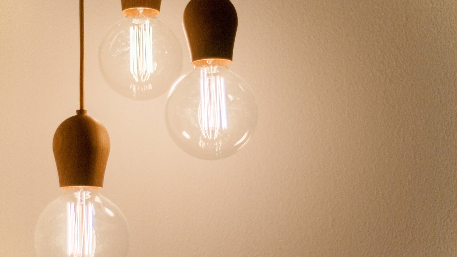 Three light bulbs hanging by cord