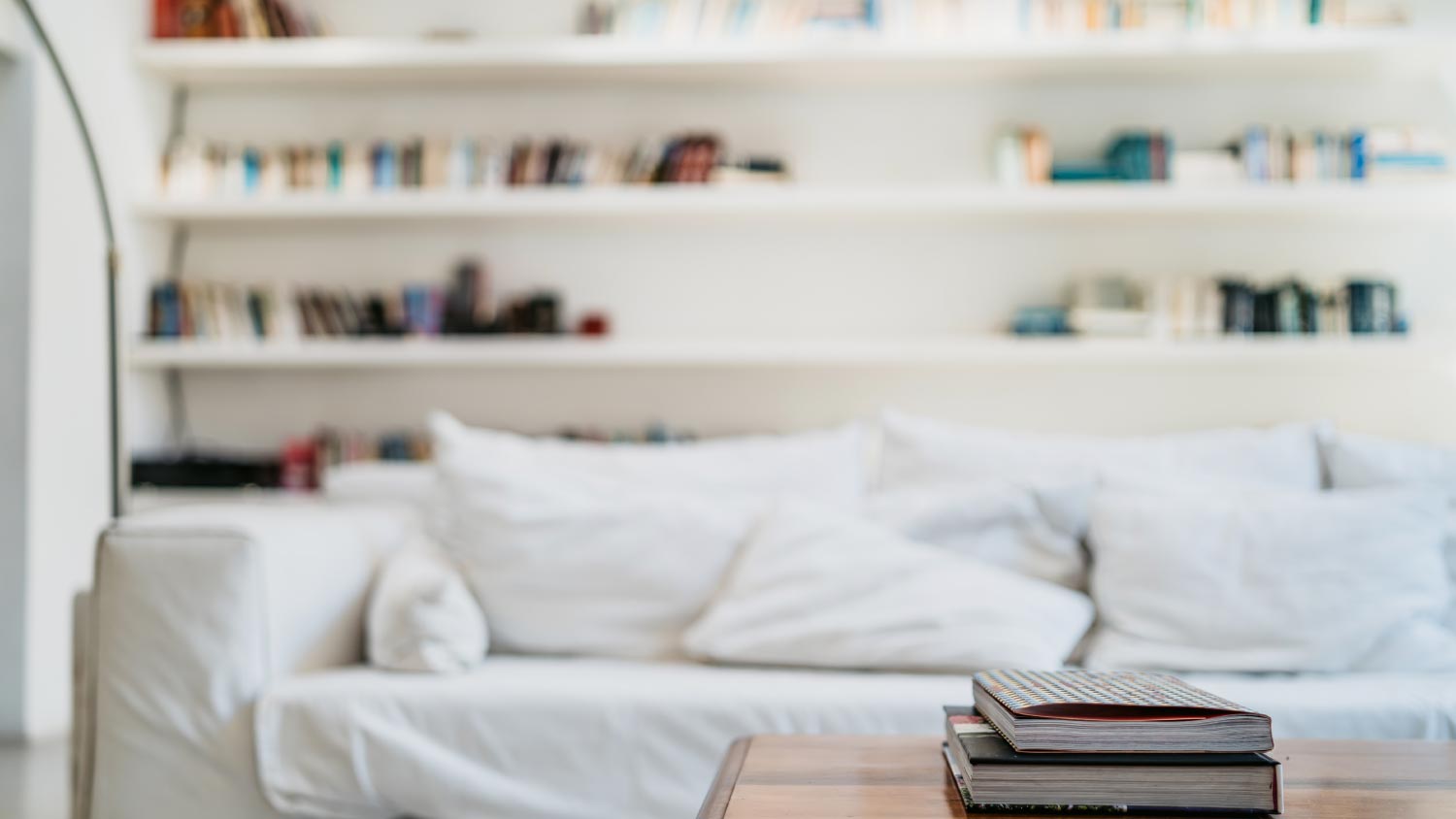white sofa in living room with big bookshelf