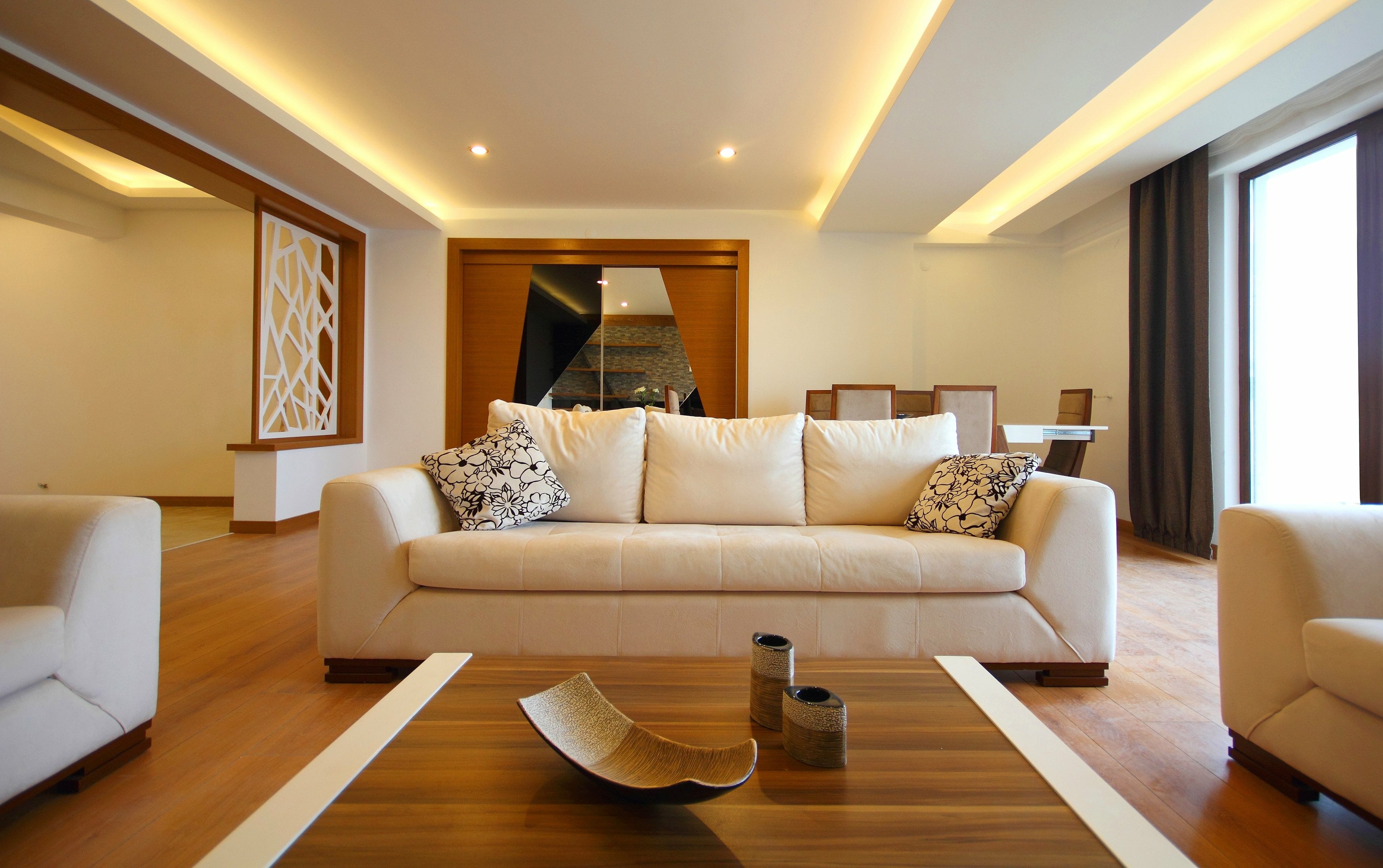 Living room with white couch and built-in lighting