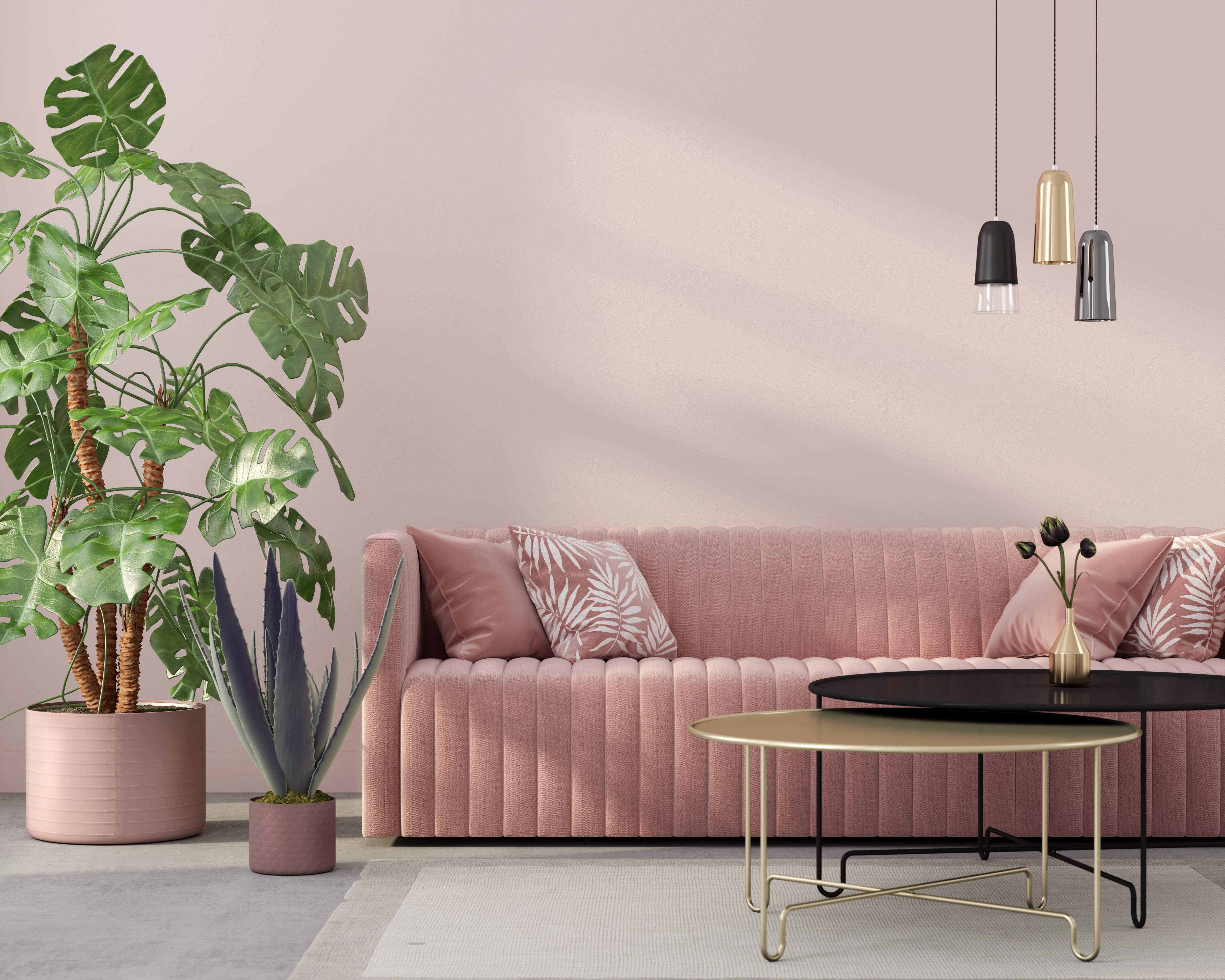 Pink living room couch with multi-tiered pendant lights