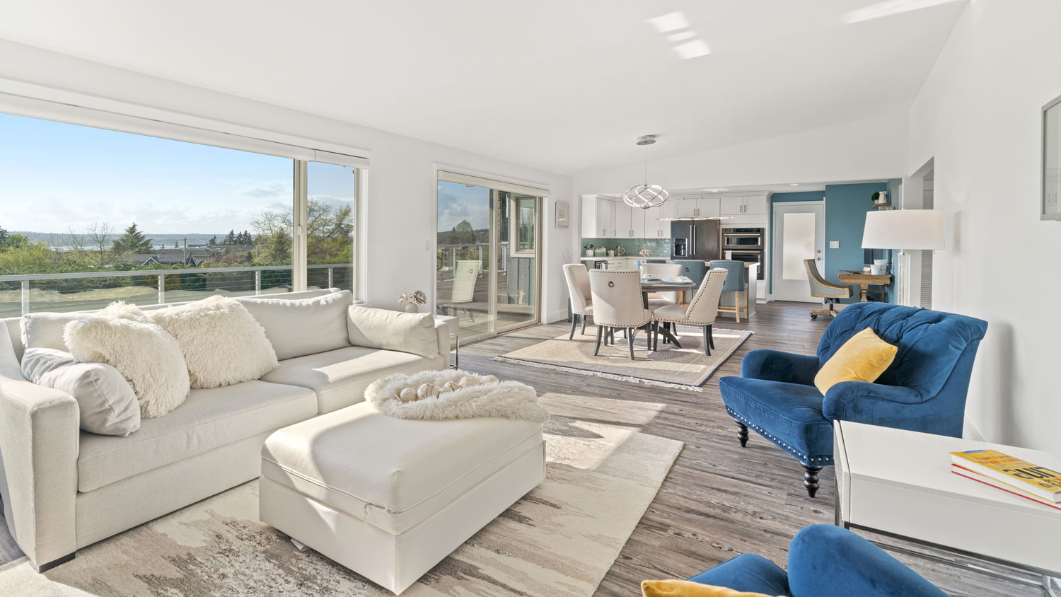 A living room and a dining area with rugs defining the areas