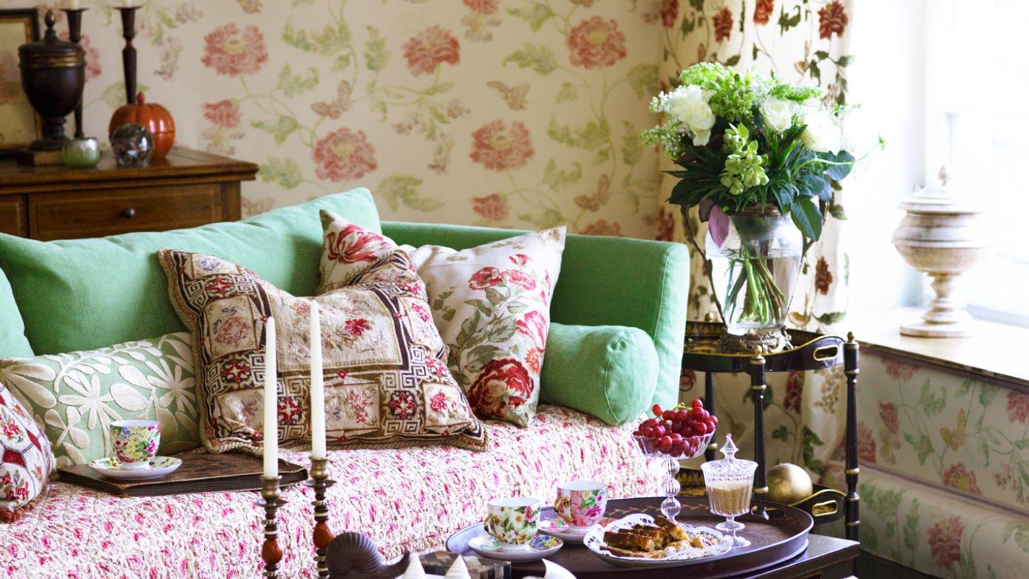 A living room interior with floral wallpaper